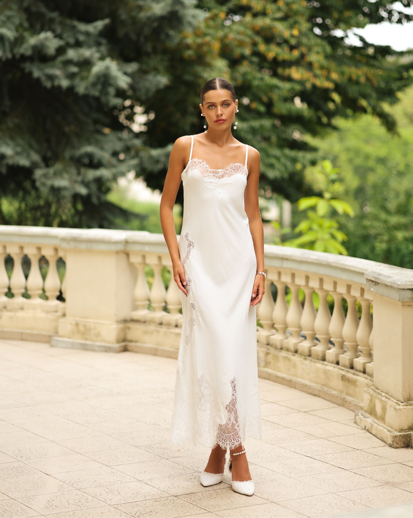 Frontal view of the long nightgown, featuring delicate lace embellishments and thin shoulder straps for a refined look.