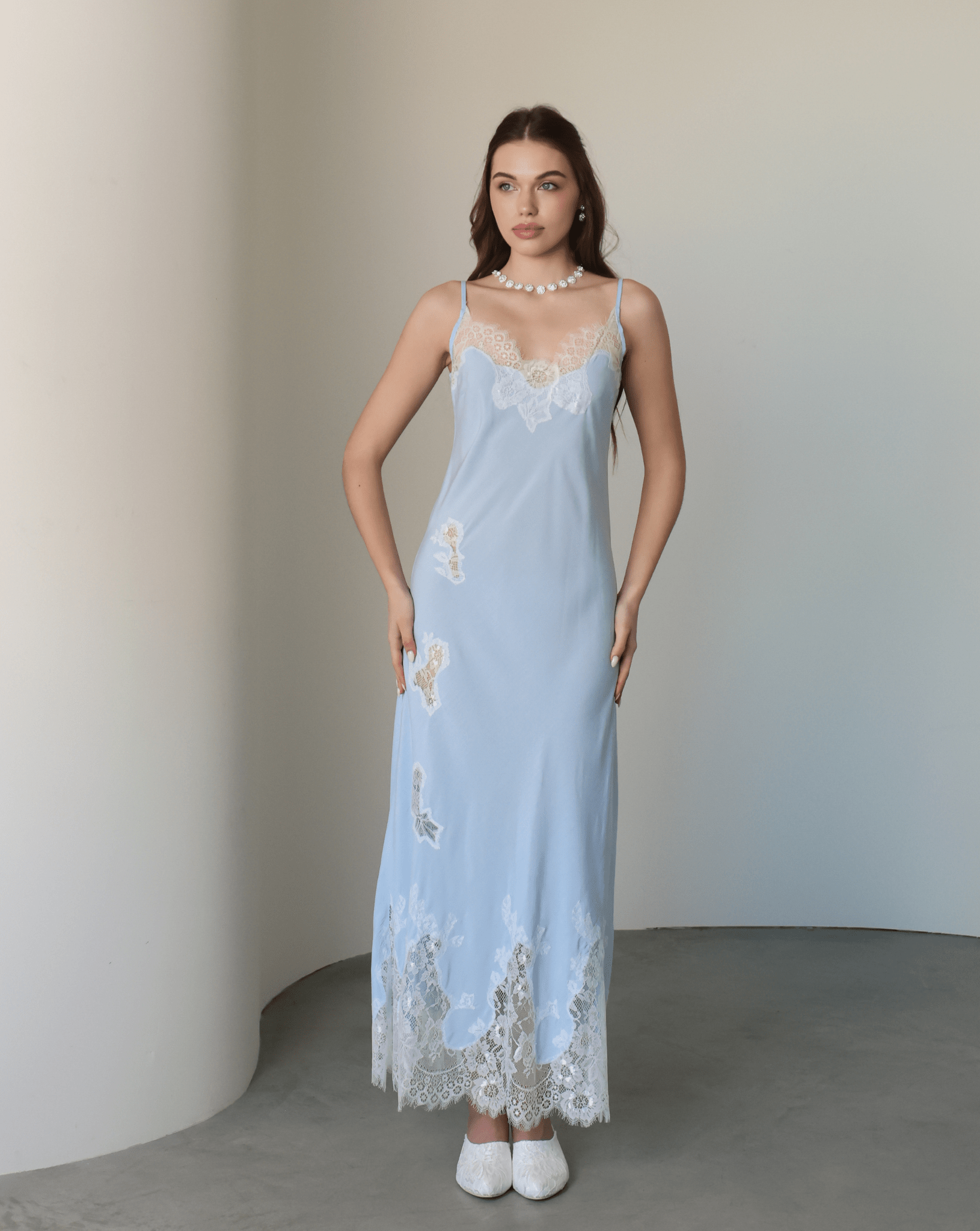 Frontal shot of the nightgown adorned with delicate lace cutouts that trace the silhouette with artistic charm.