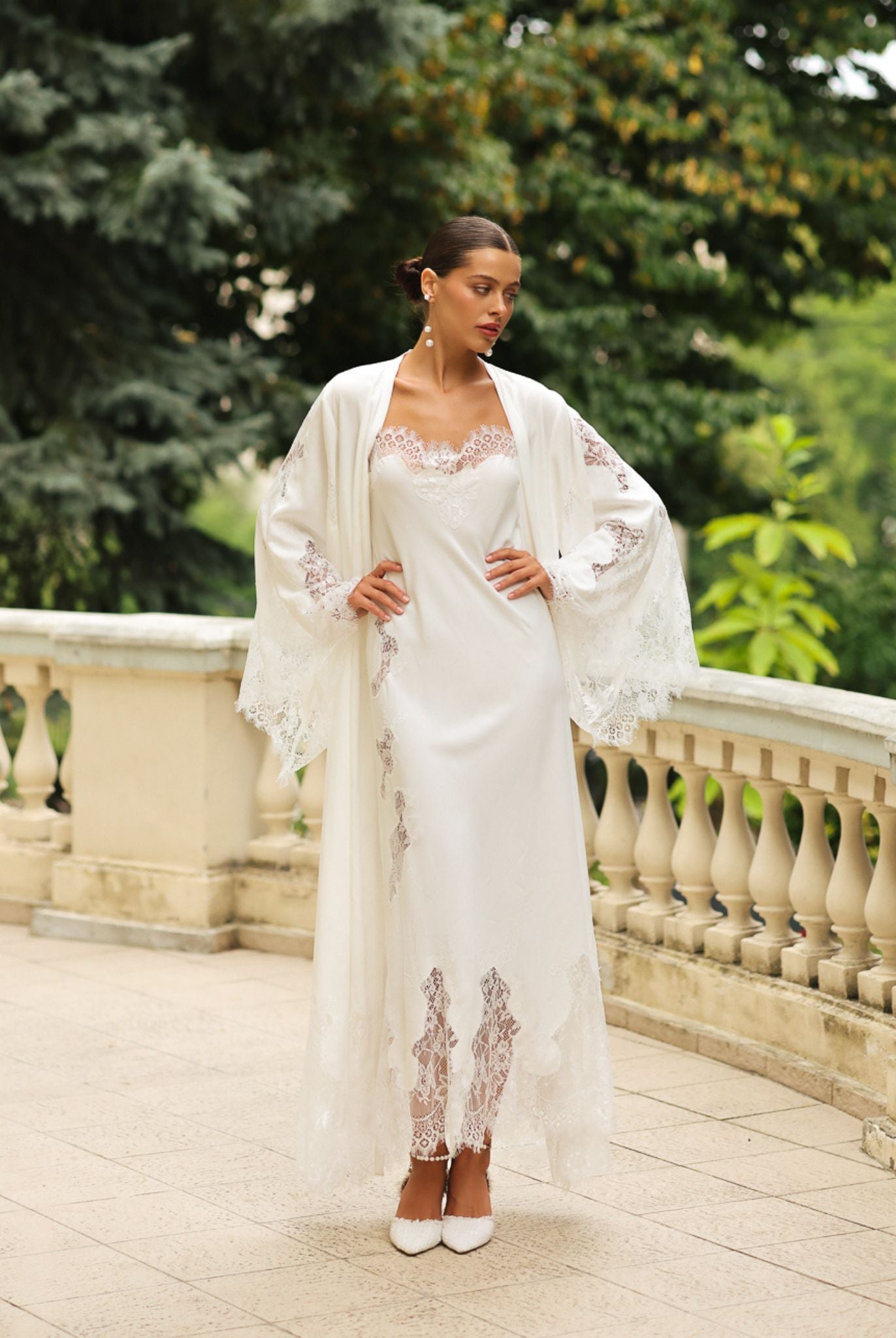 Standing pose with hands on the waist to display the wide sleeves of the Robe and Nightgown Set and its lace trim.