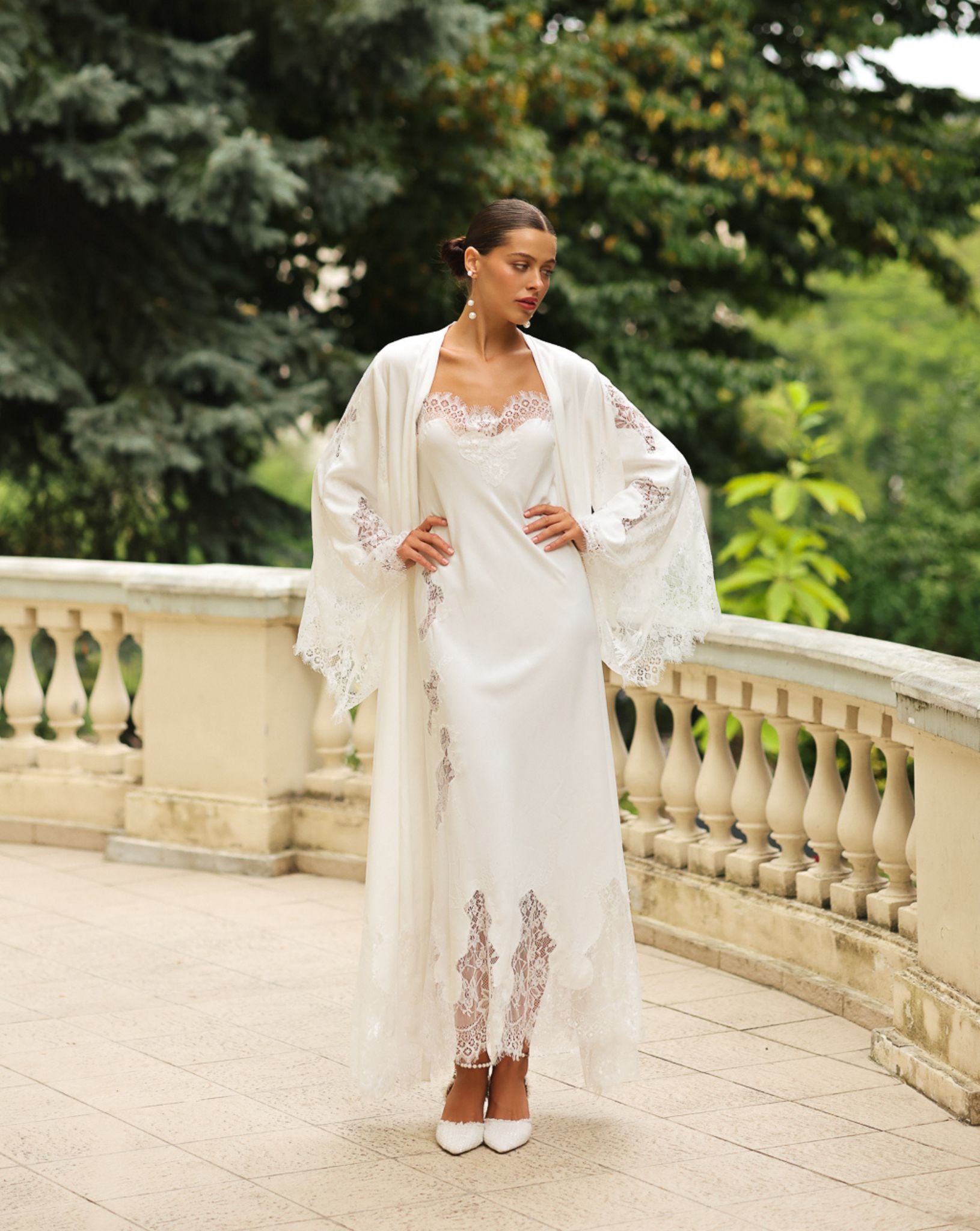 Standing pose with hands on the waist to display the wide sleeves of the Robe and Nightgown Set and its lace trim.