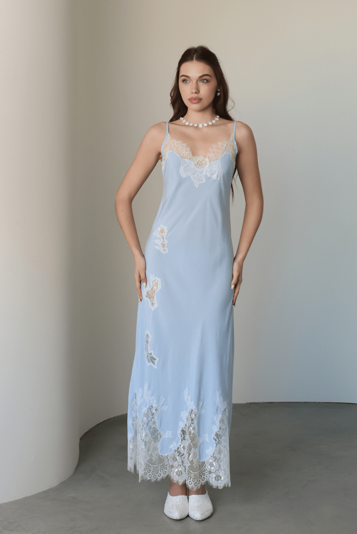 Frontal shot of the nightgown adorned with delicate lace cutouts that trace the silhouette with artistic charm.