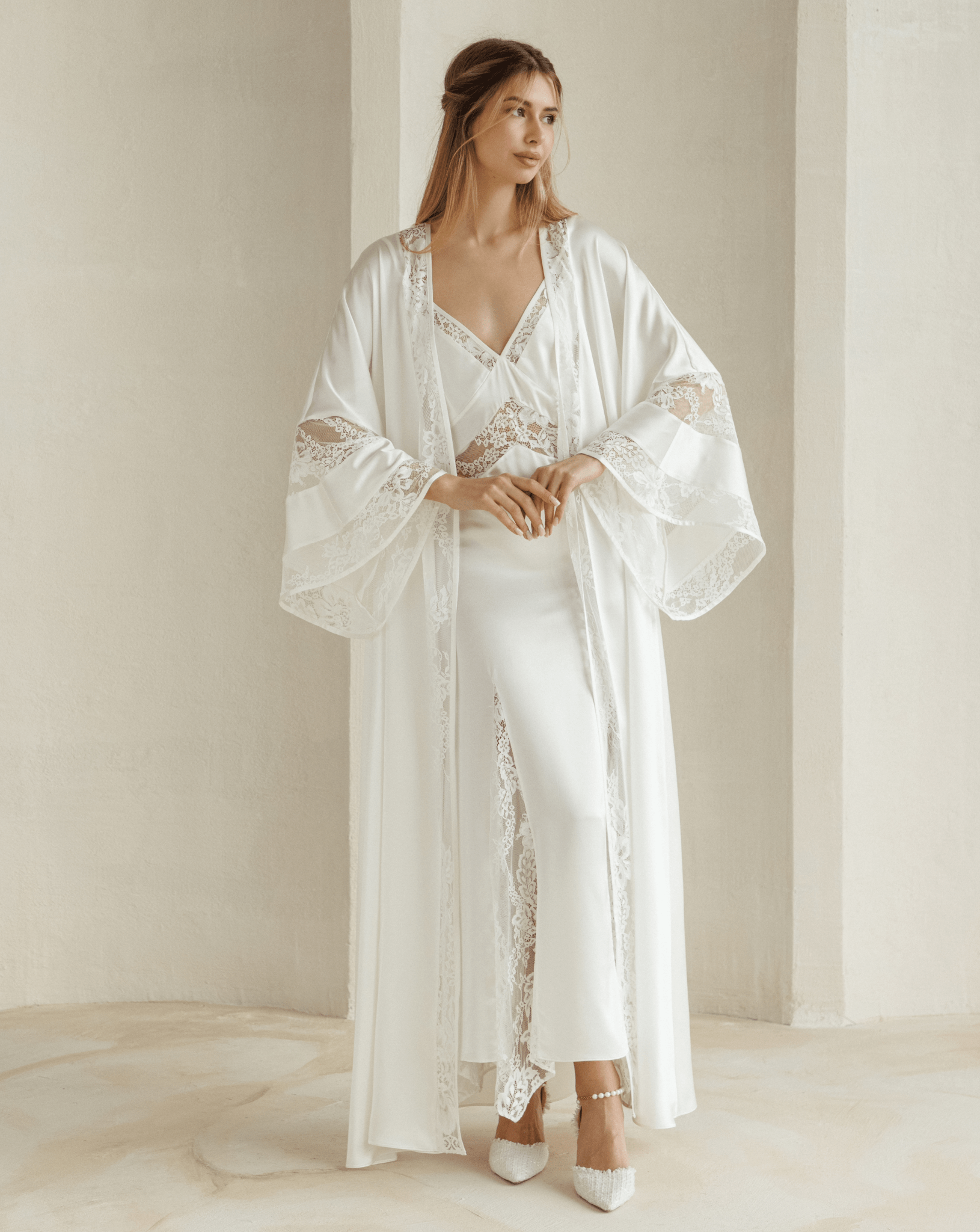Model wearing Inamorata Silk Robe and Nightgown Set in ivory satin with lace trim