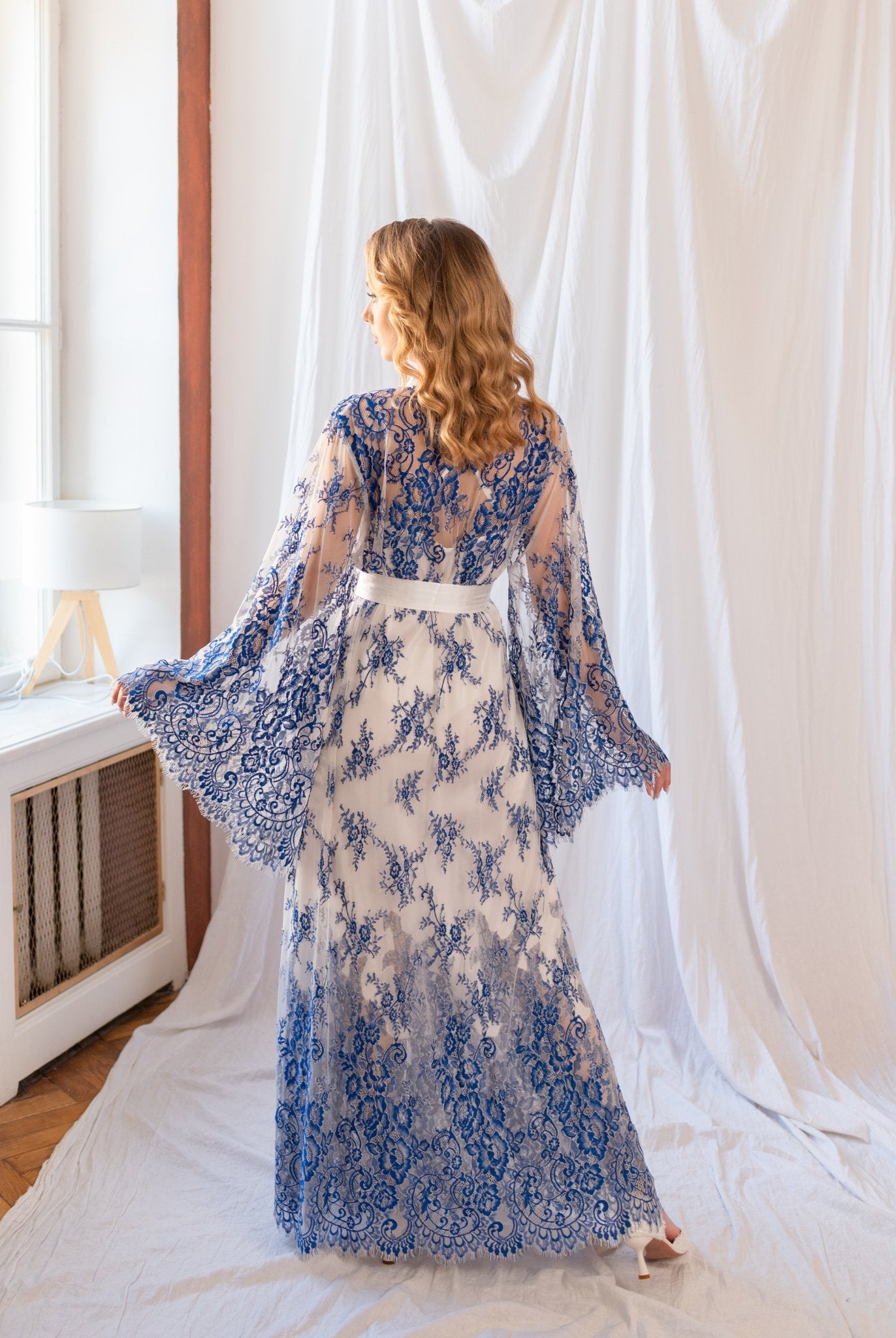 Blue and white lace robe layered over full-length white gown - backview