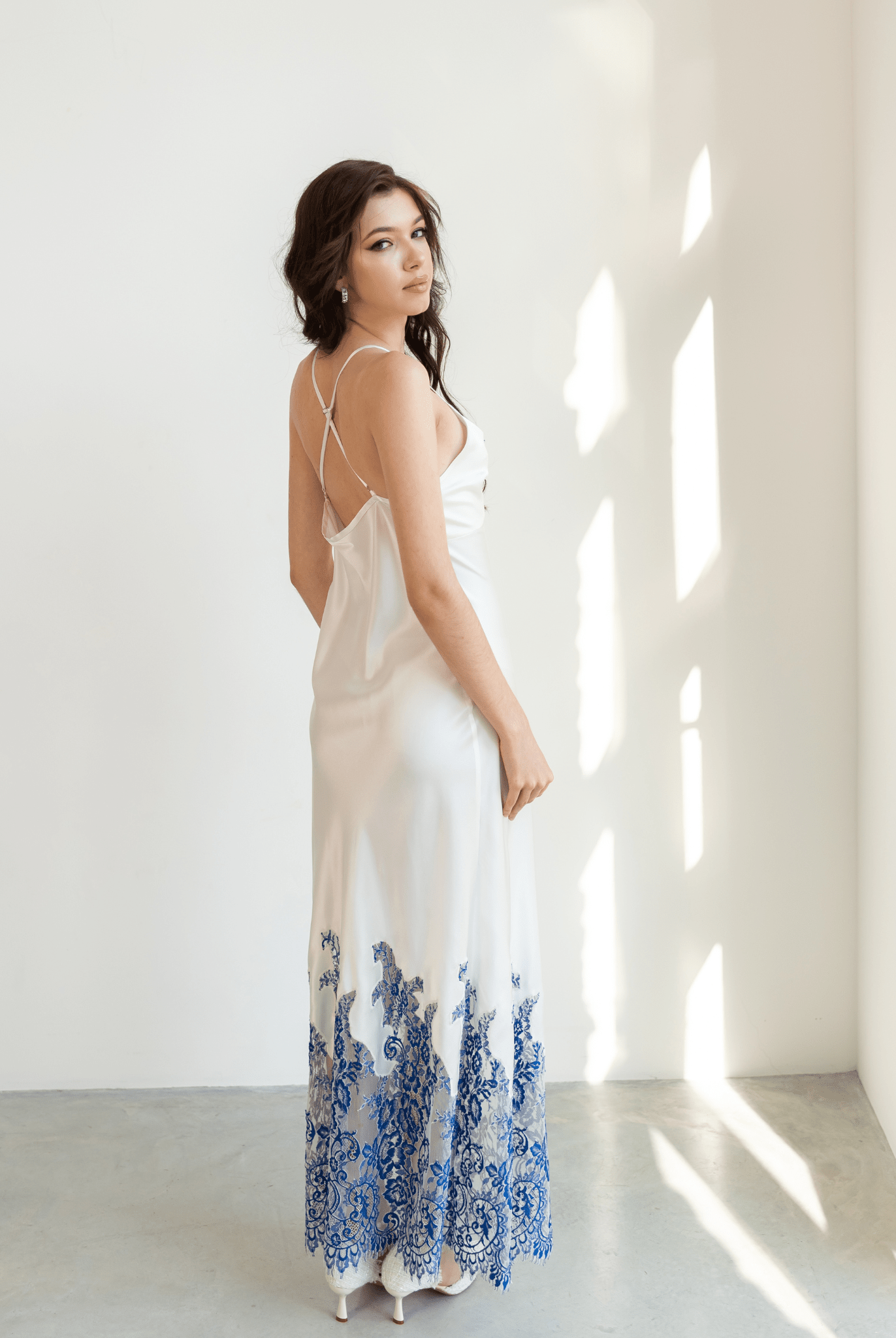 Side view of silk nightgown with blue lace hem and open back