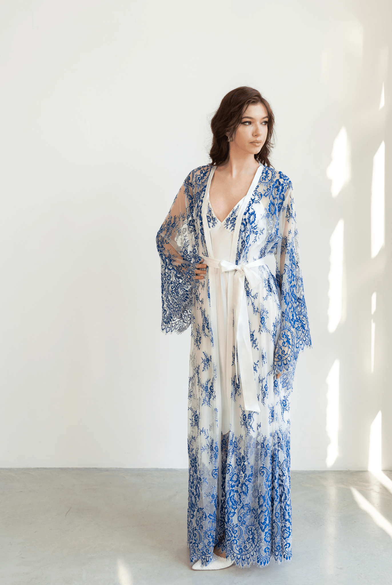 Blue and white lace robe layered over full-length white gown