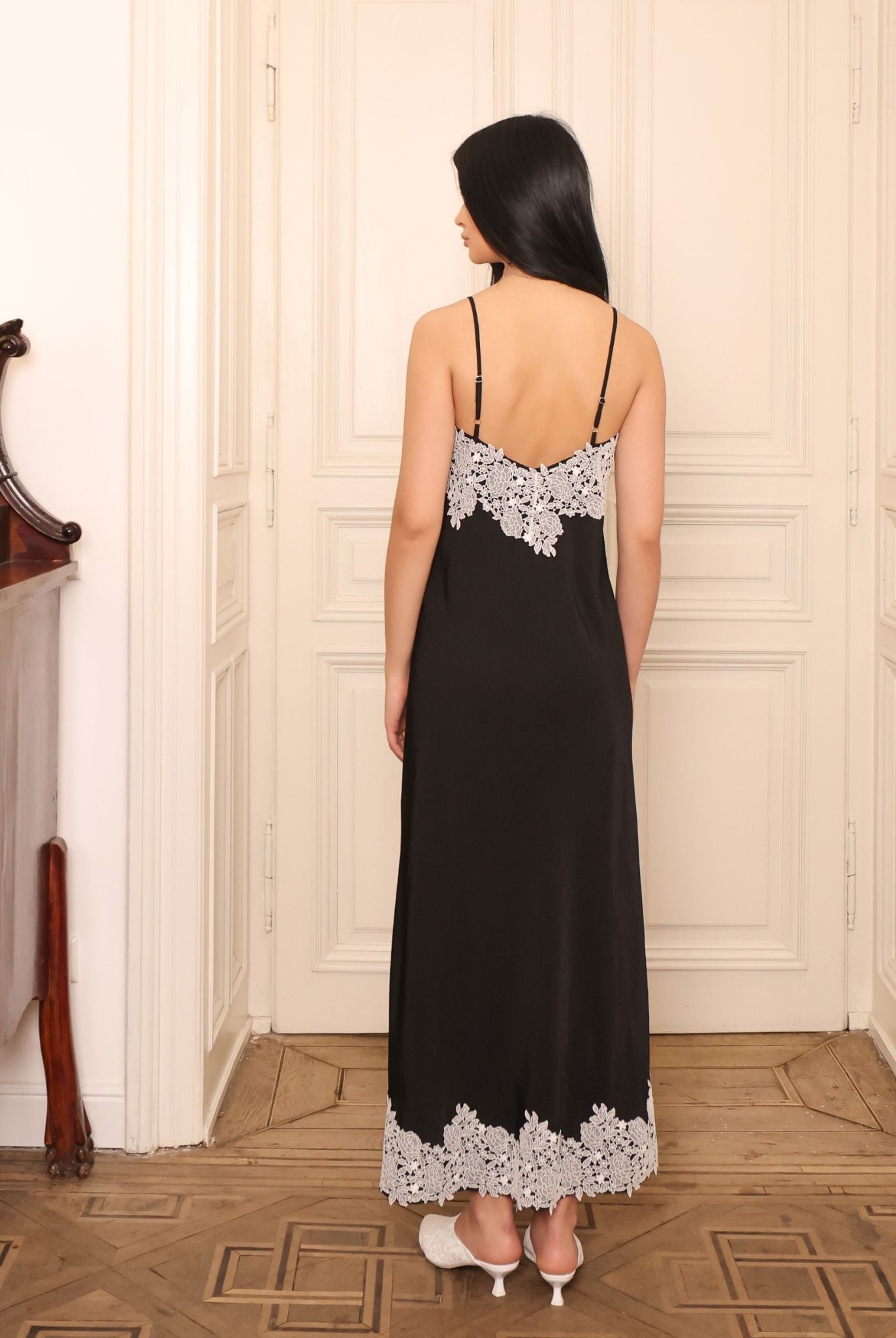 Rear view of the slip dress, showcasing the unexpected lace panel that reveals itself subtly during movement.