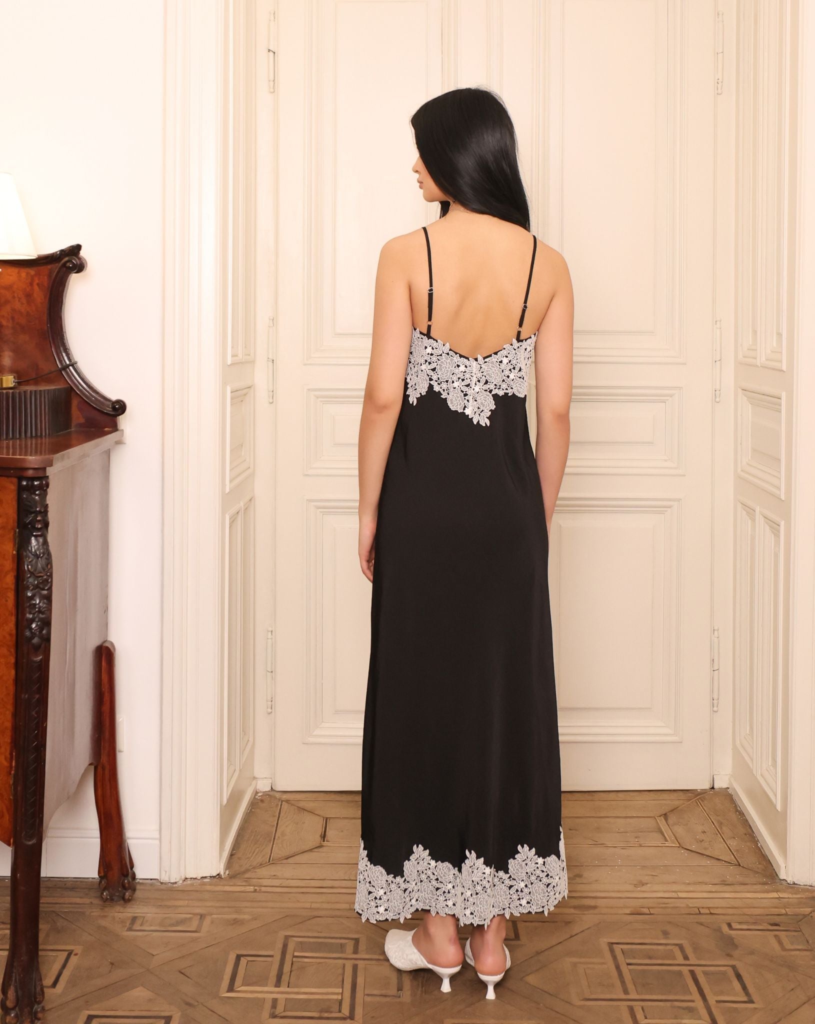 Rear view of the slip dress, showcasing the unexpected lace panel that reveals itself subtly during movement.