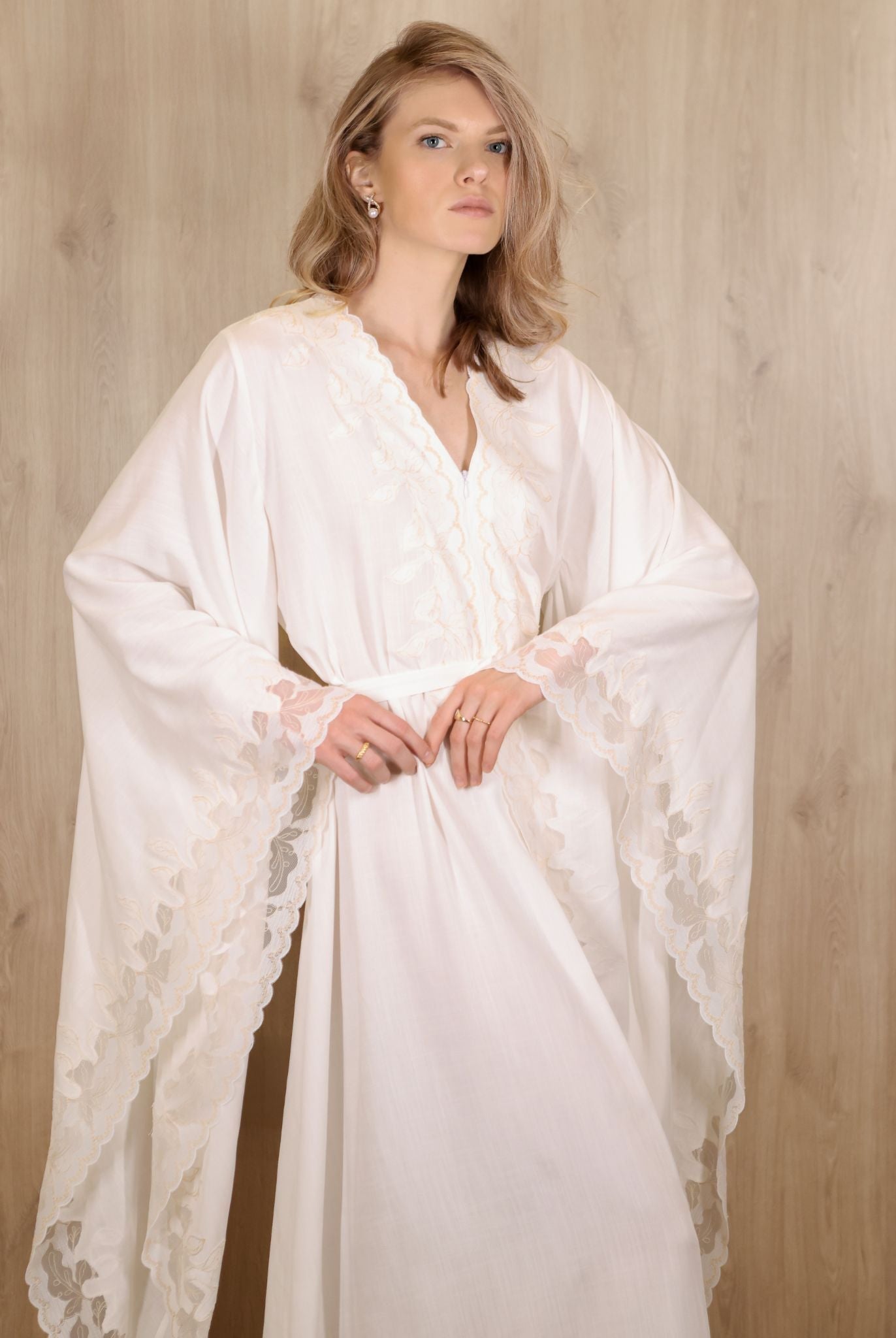 Mid-length view from head to knees, focusing on the wide sleeves and subtle lace detailing at the edges.