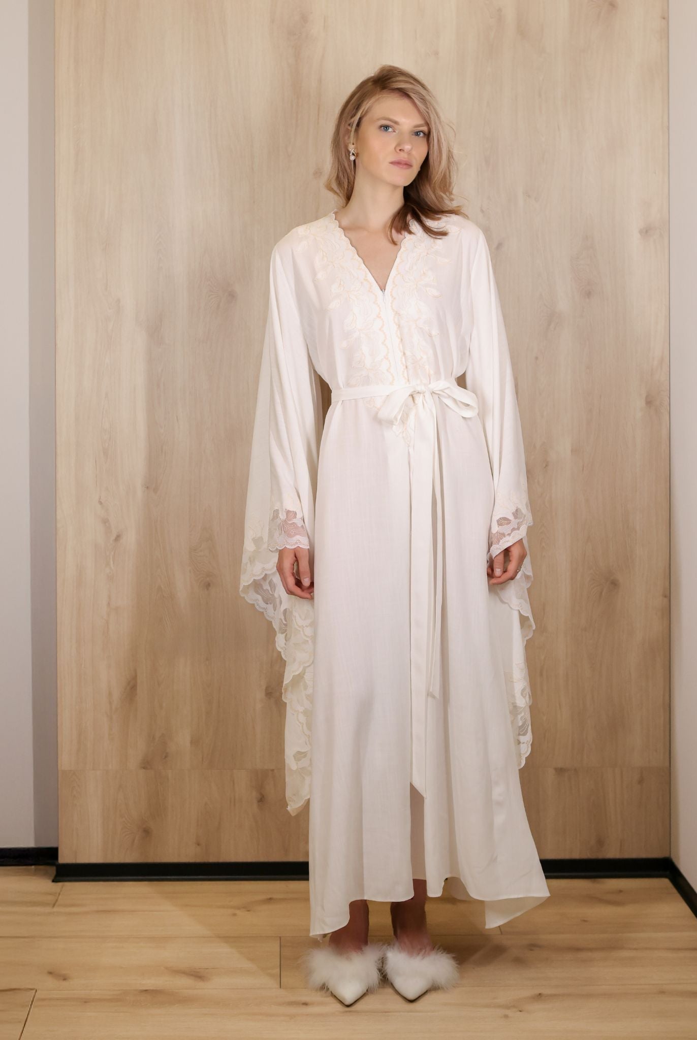 Standing full-length view of the maternity attire, showcasing the relaxed silhouette and graceful floor-length design.