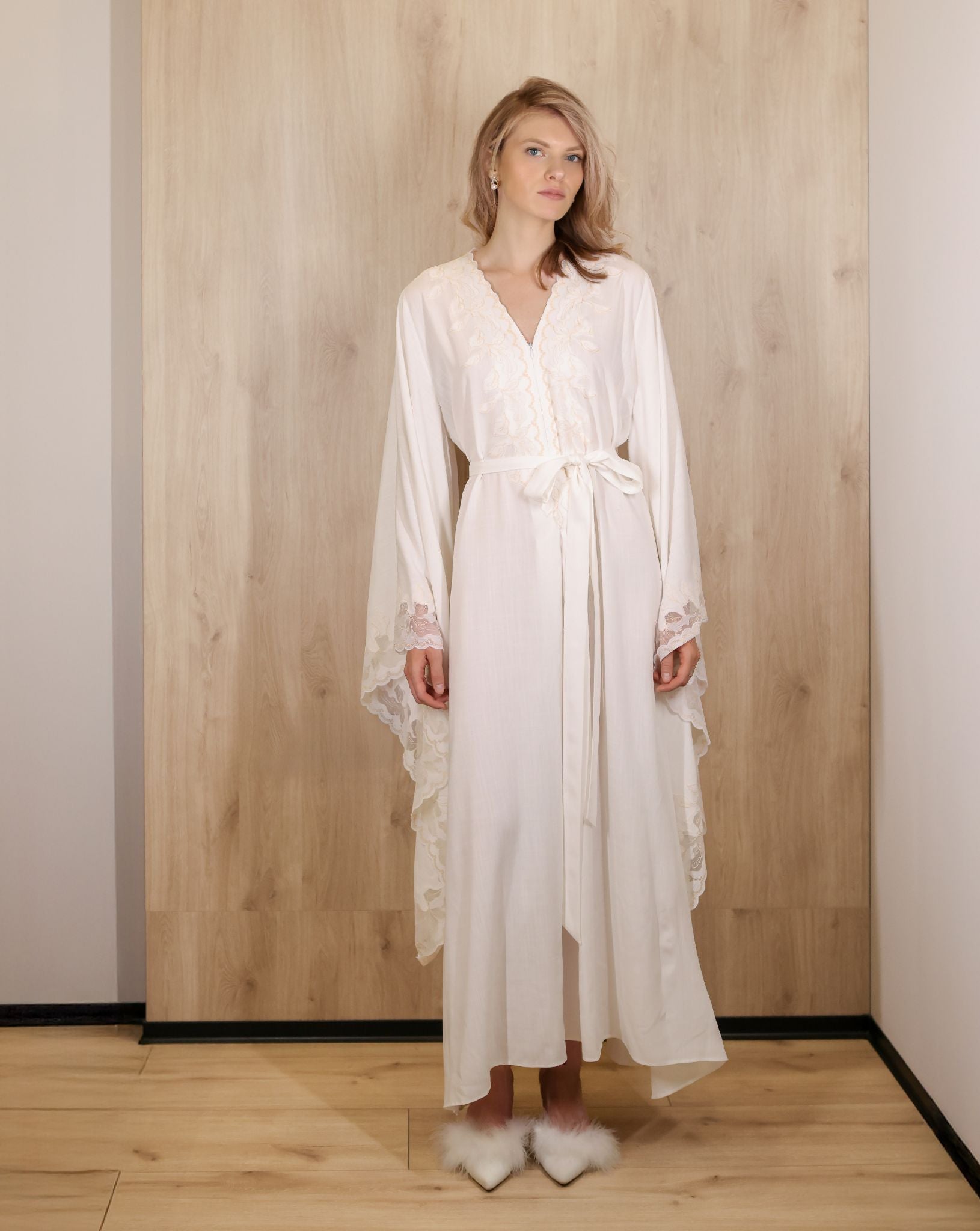 Standing full-length view of the maternity attire, showcasing the relaxed silhouette and graceful floor-length design.