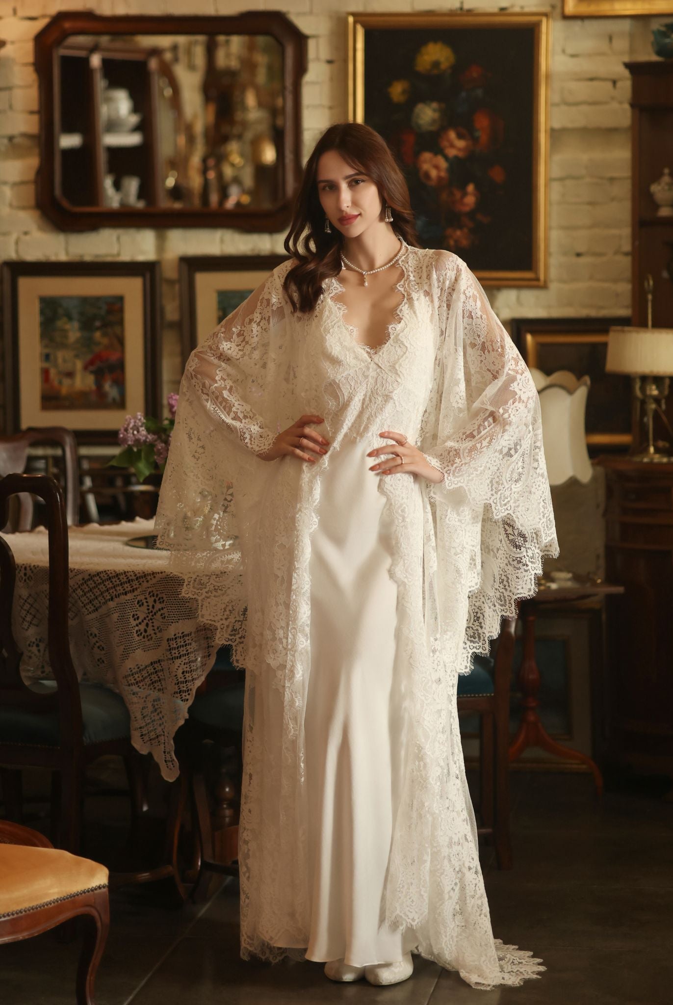 A posed view of the Bridal Robe and Nightgown Set with hands on the waist to showcase the airy lace sleeves.