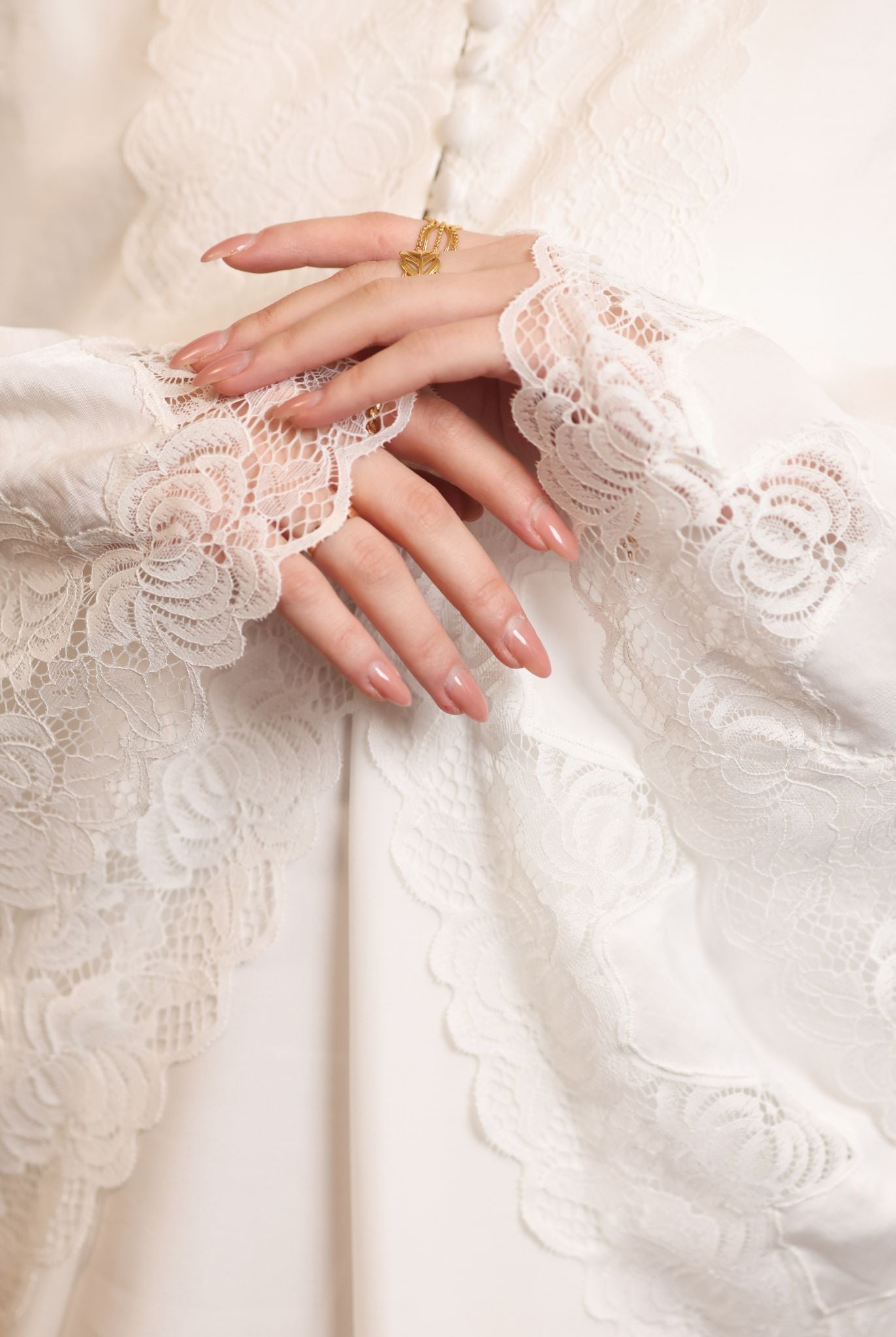 Close-up of the wide sleeves finished with exquisite lace, adding a gentle movement to every gesture.