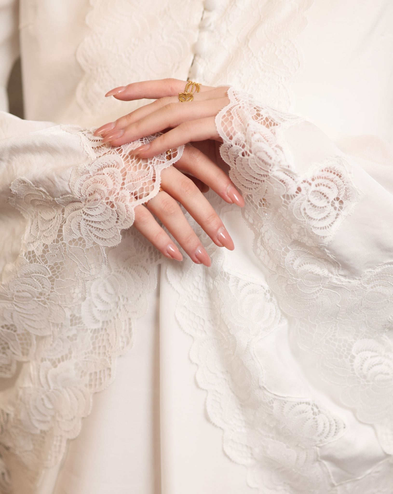 Close-up of the wide sleeves finished with exquisite lace, adding a gentle movement to every gesture.