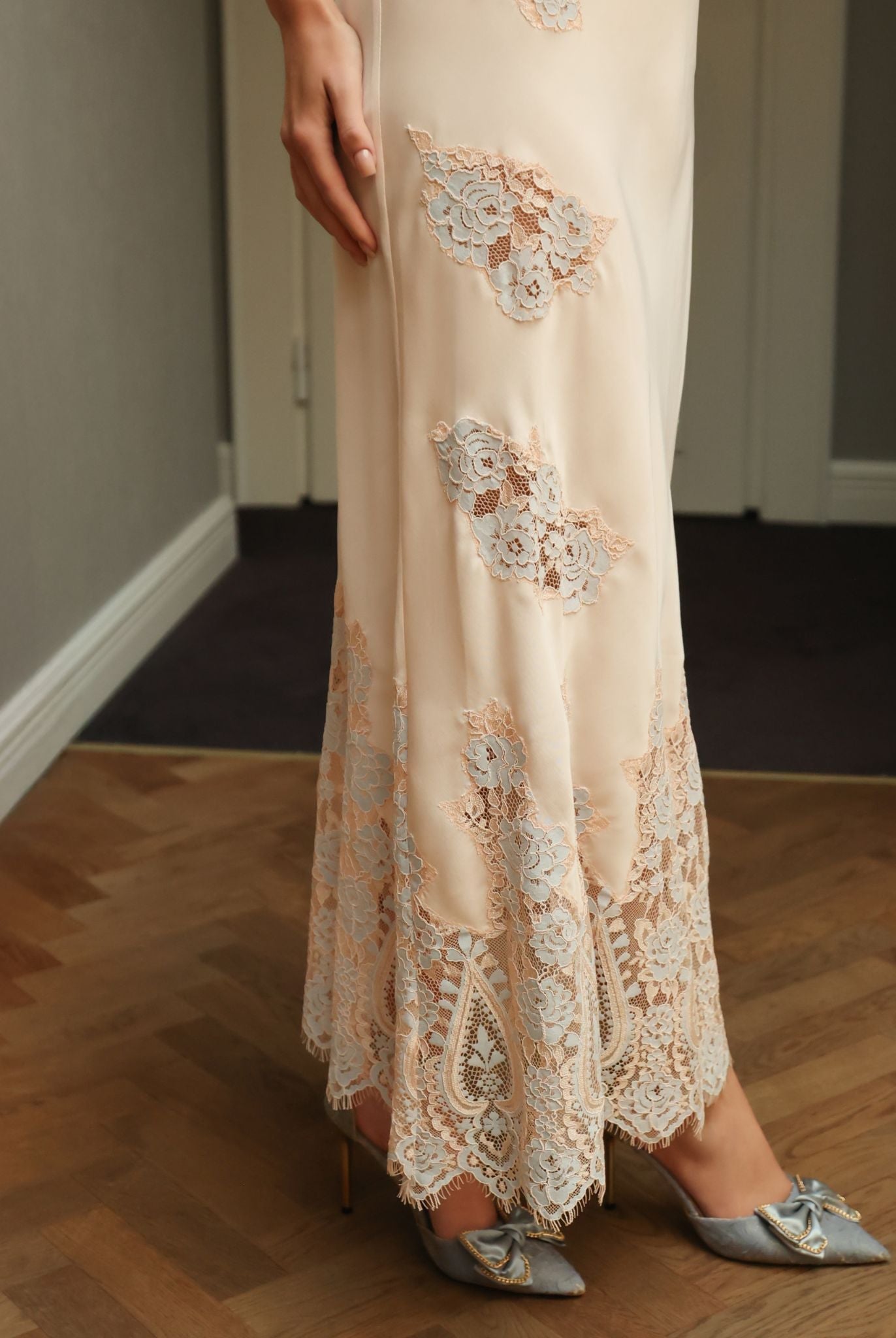 Close-up of the hem featuring scattered lace appliqués, adding a touch of sophisticated luxury to the set.