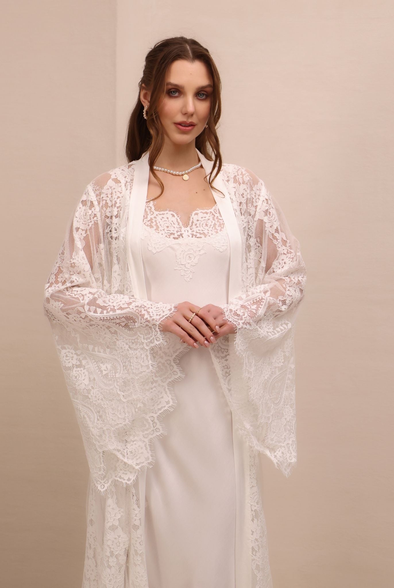 A mid-length shot focusing on the wide sleeves and the delicate lace along the neckline for a feminine look.
