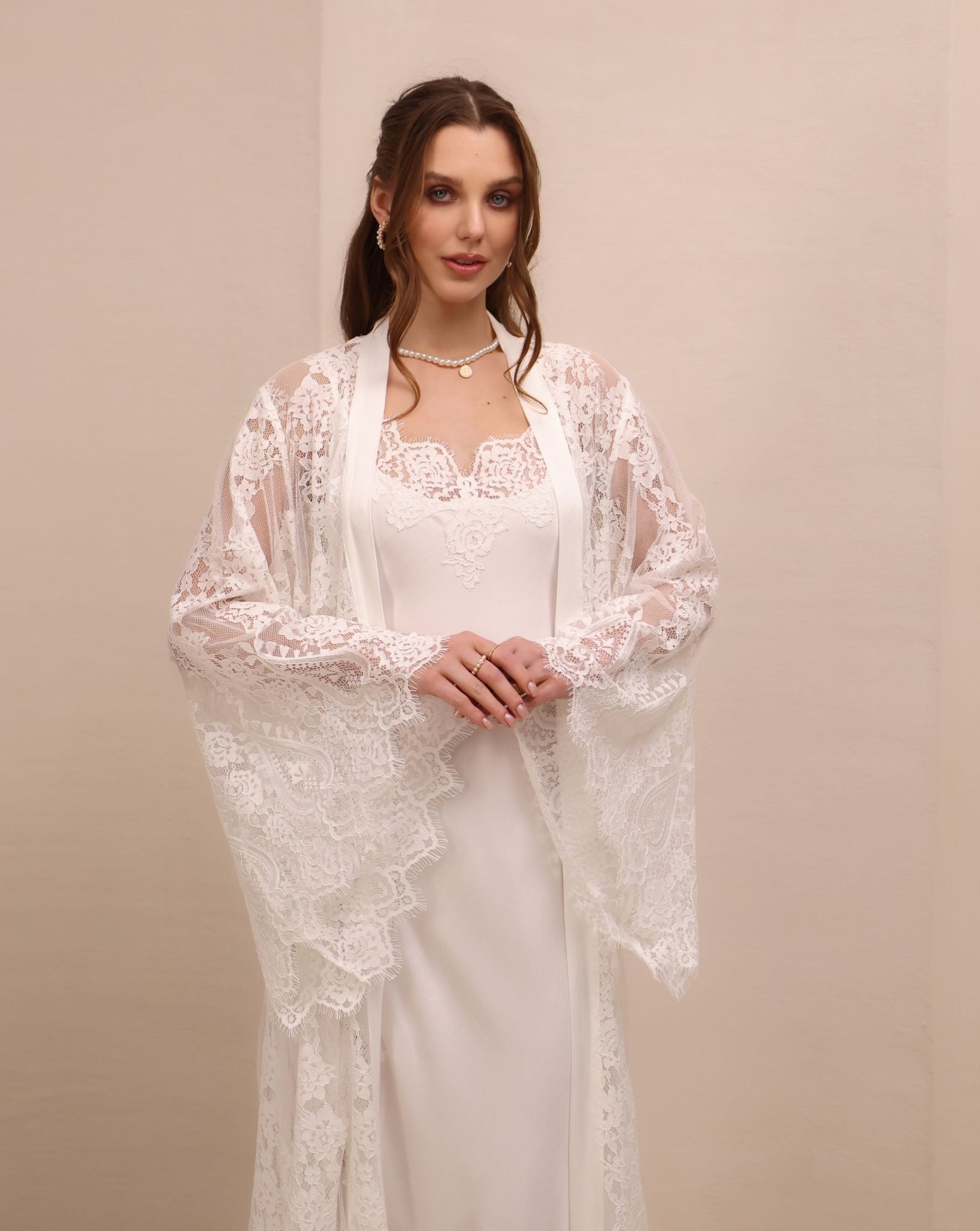 A mid-length shot focusing on the wide sleeves and the delicate lace along the neckline for a feminine look.