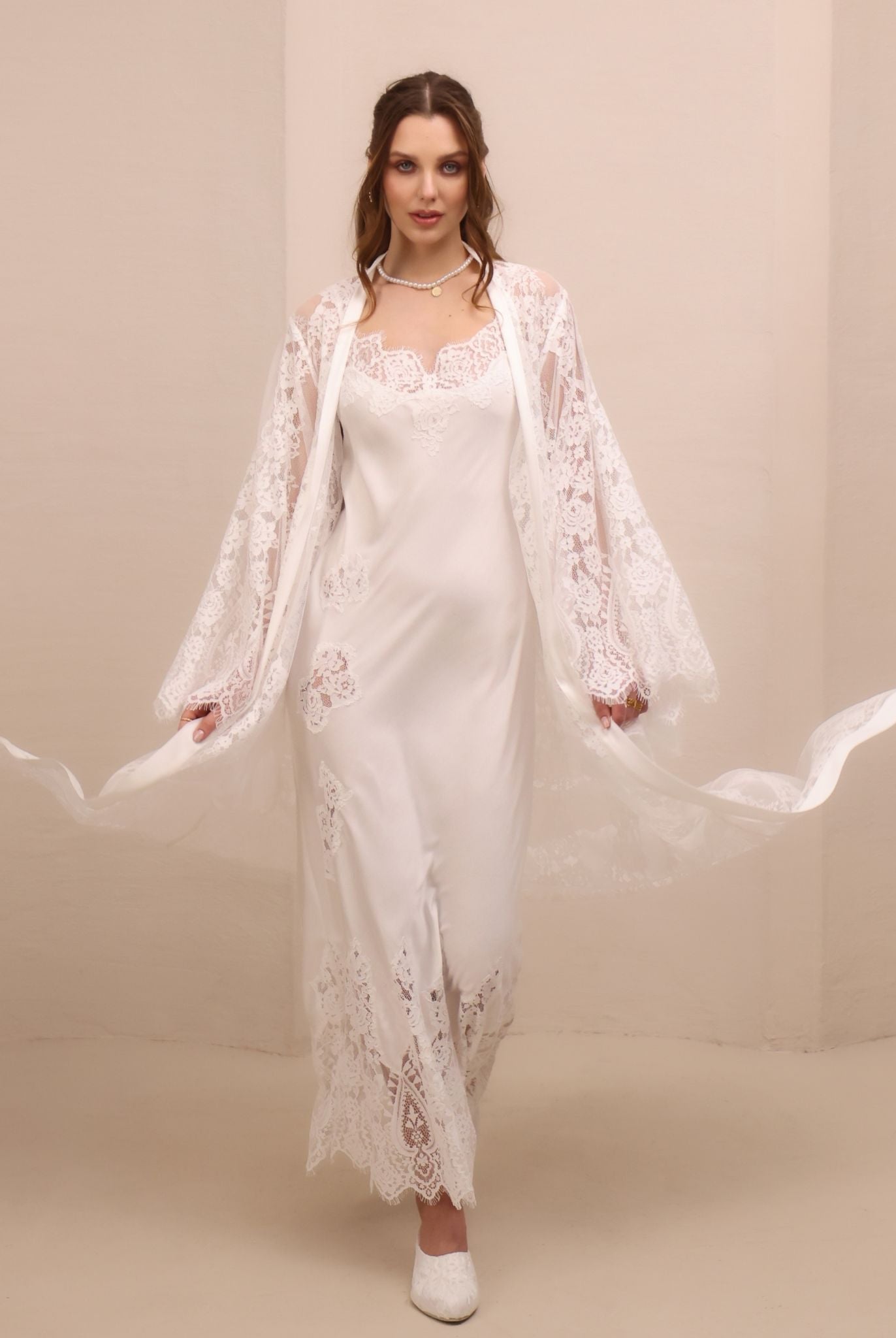 A dynamic motion shot of the lace robe flowing to both sides, capturing the airy movement of the floor-length cut.