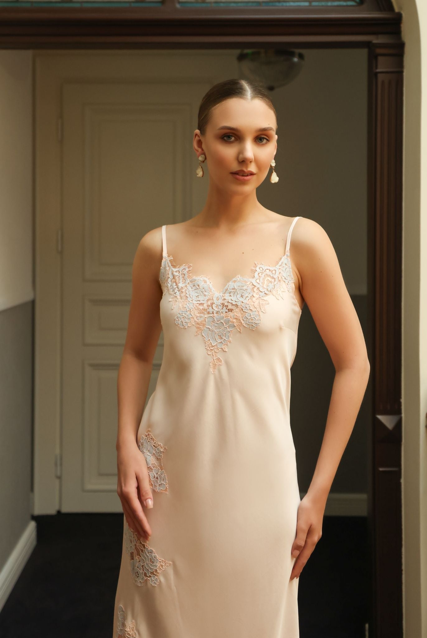 Mid-length shot of the sleeveless nightgown, showcasing the soft feminine silhouette and refined lace details.