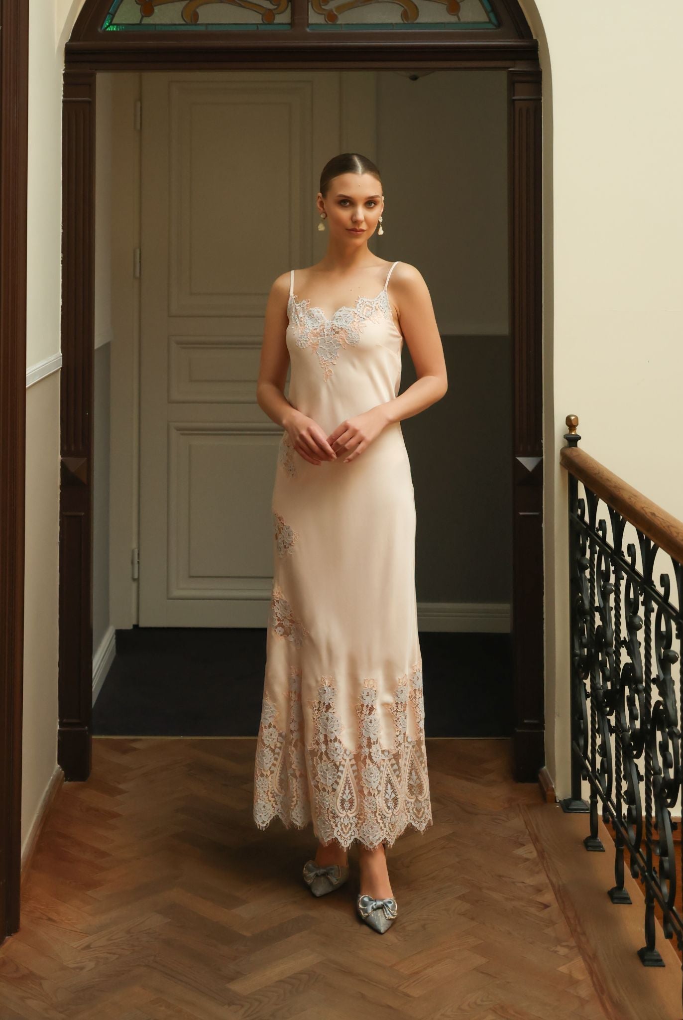 Front view of the cotton nightgown featuring delicate lace along the neckline and scattered artistic appliqués.