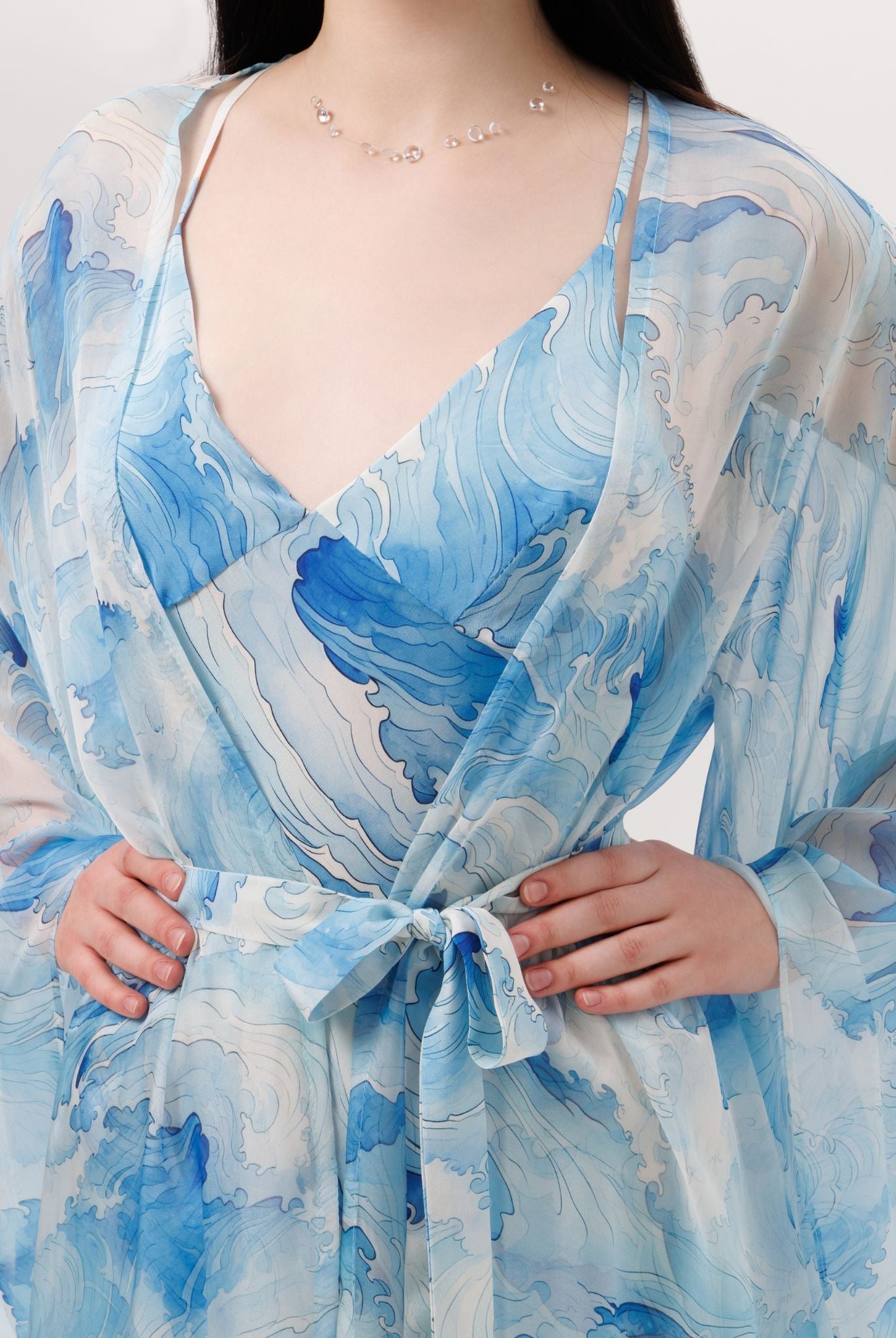 Close-up of the wrapped robe at the waist, highlighting the natural elegance and understated luxury of the silk crepe.