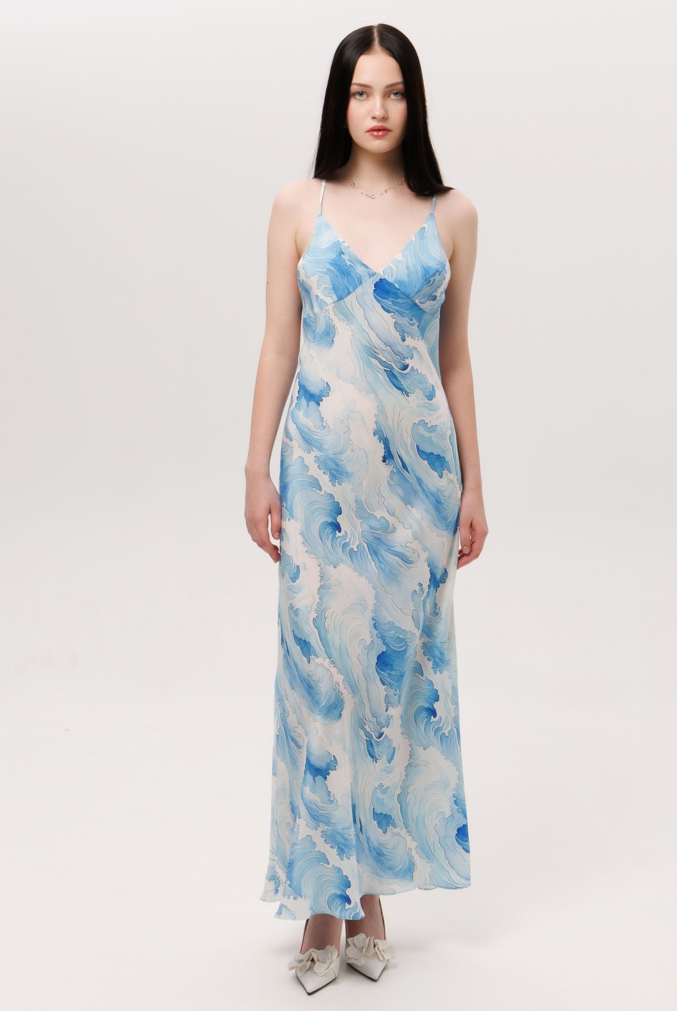 Front view of the silk slip dress featuring a delicate V-neckline and a smooth, flowing silhouette that feels effortless.