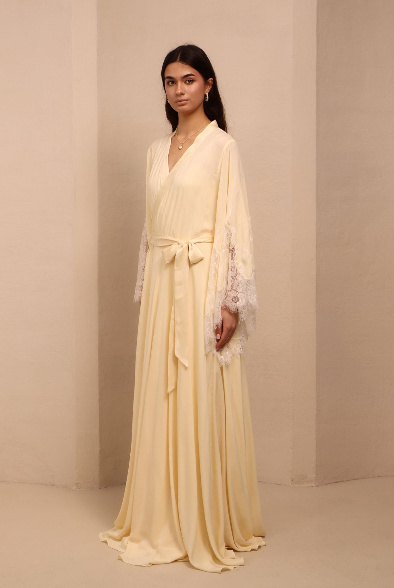 Side view of the tied ensemble, highlighting the long, graceful lines and the intricate lace detailing at the ends.