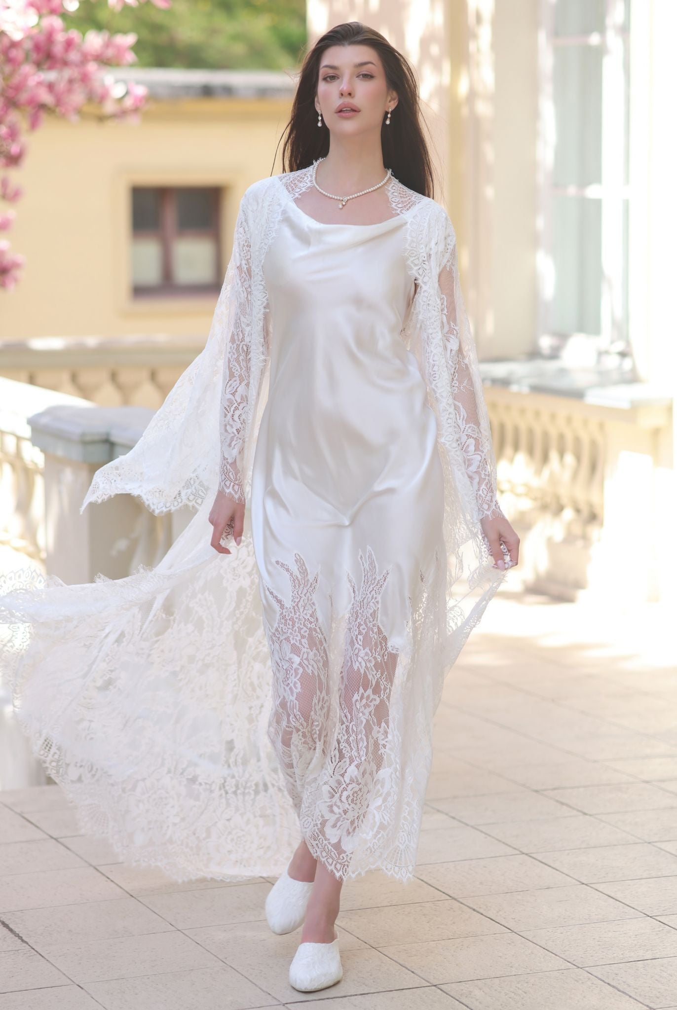 A motion shot of the Silk Robe and Nightgown Set, capturing the fluid movement of the lace robe and silk hem.