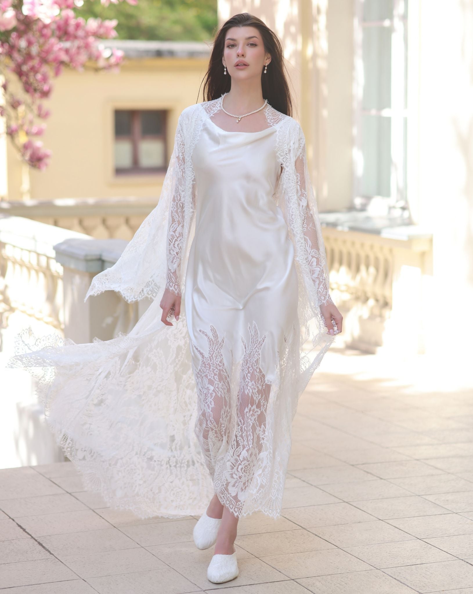 A motion shot of the Silk Robe and Nightgown Set, capturing the fluid movement of the lace robe and silk hem.
