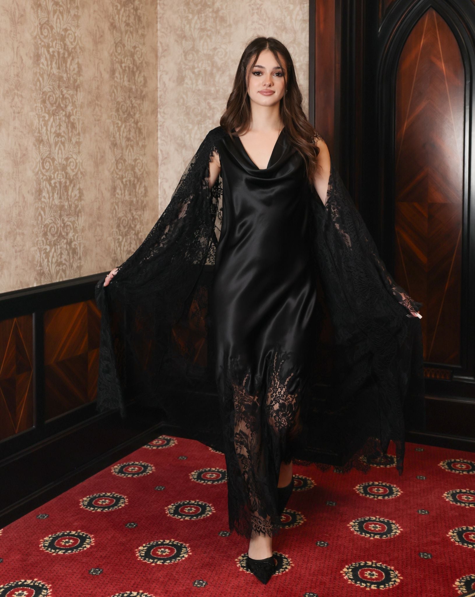 Motion shot of the layered set, illustrating the fluid definition of the silk sash and the movement of the lace.