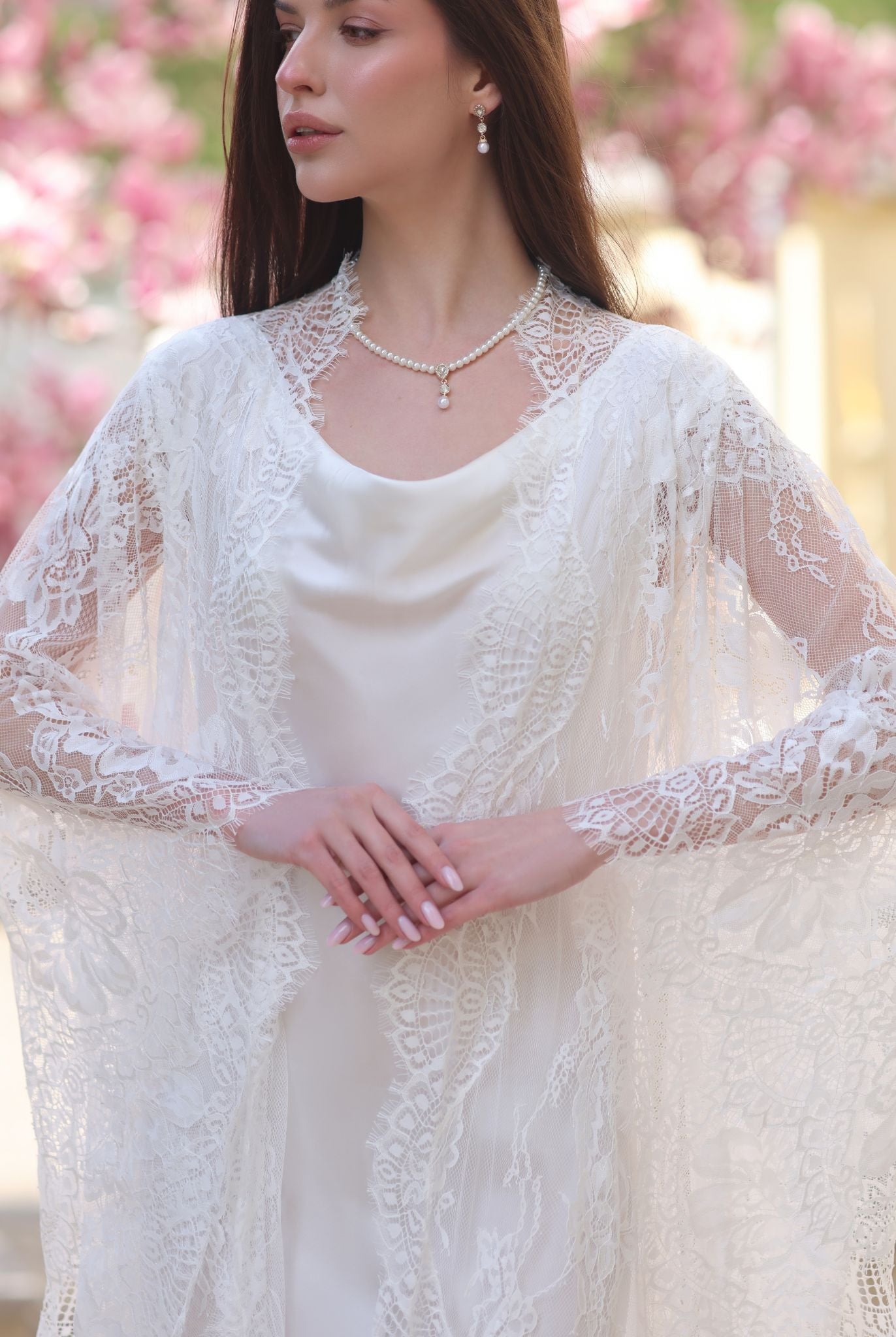 A detailed view from head to hips, focusing on the intricate lace of the robe and the soft texture of the silk.