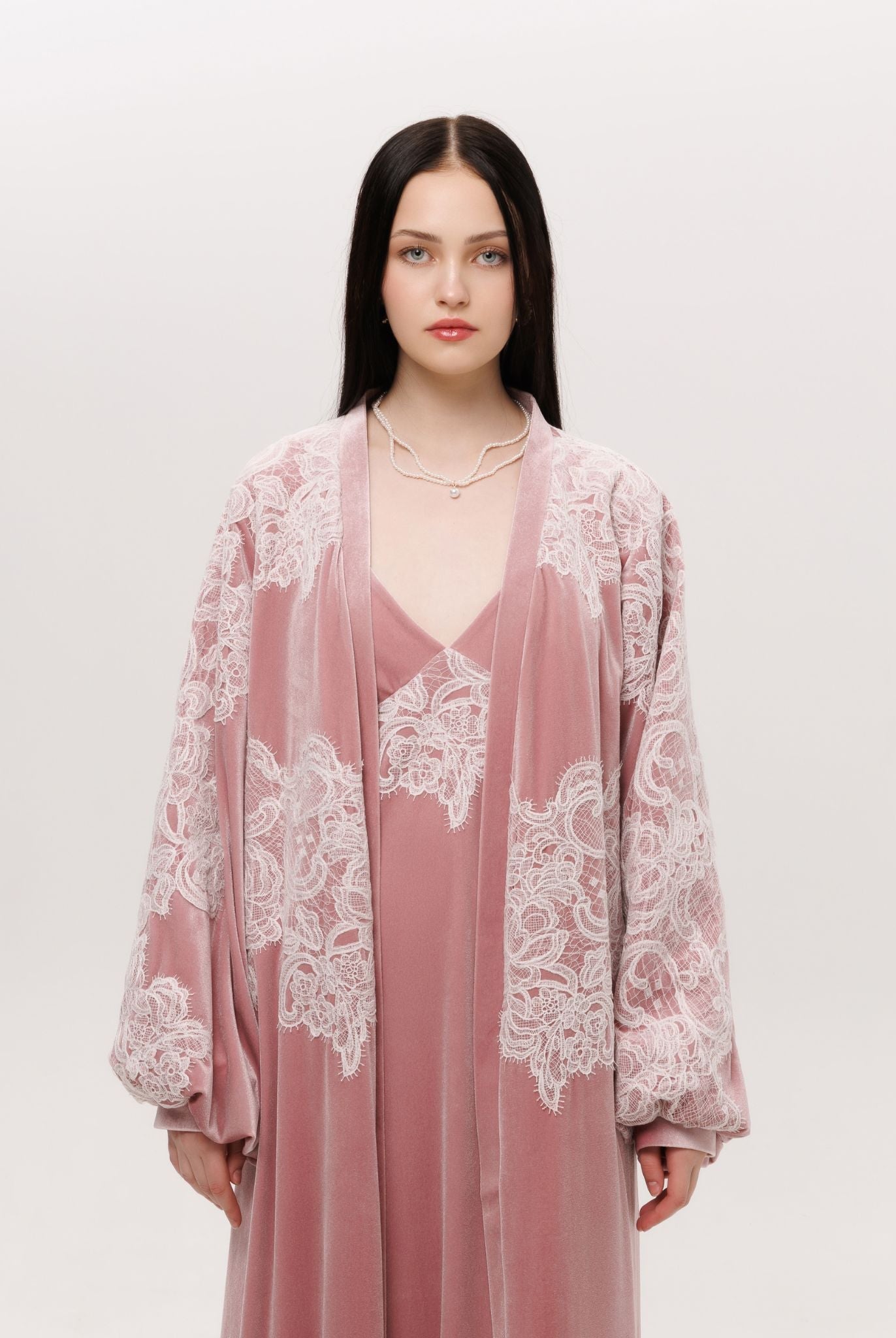 Mid-length shot of the ensemble focusing on the lace that traces the sleeves and chest like delicate frost.