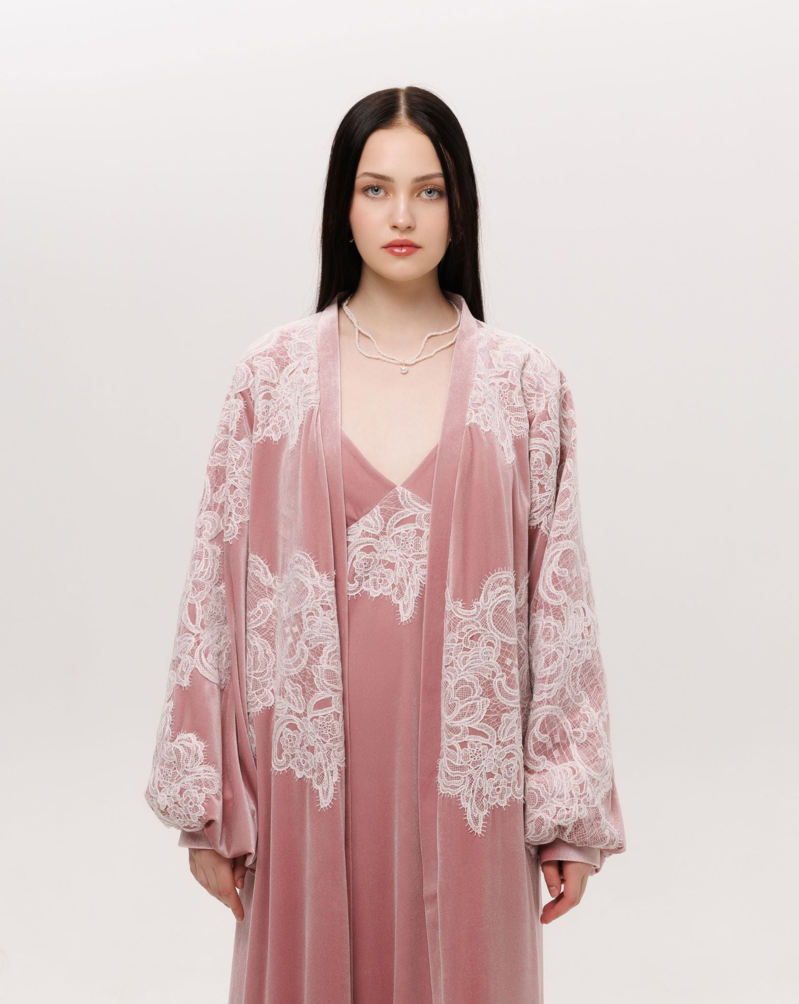 Mid-length shot of the ensemble focusing on the lace that traces the sleeves and chest like delicate frost.