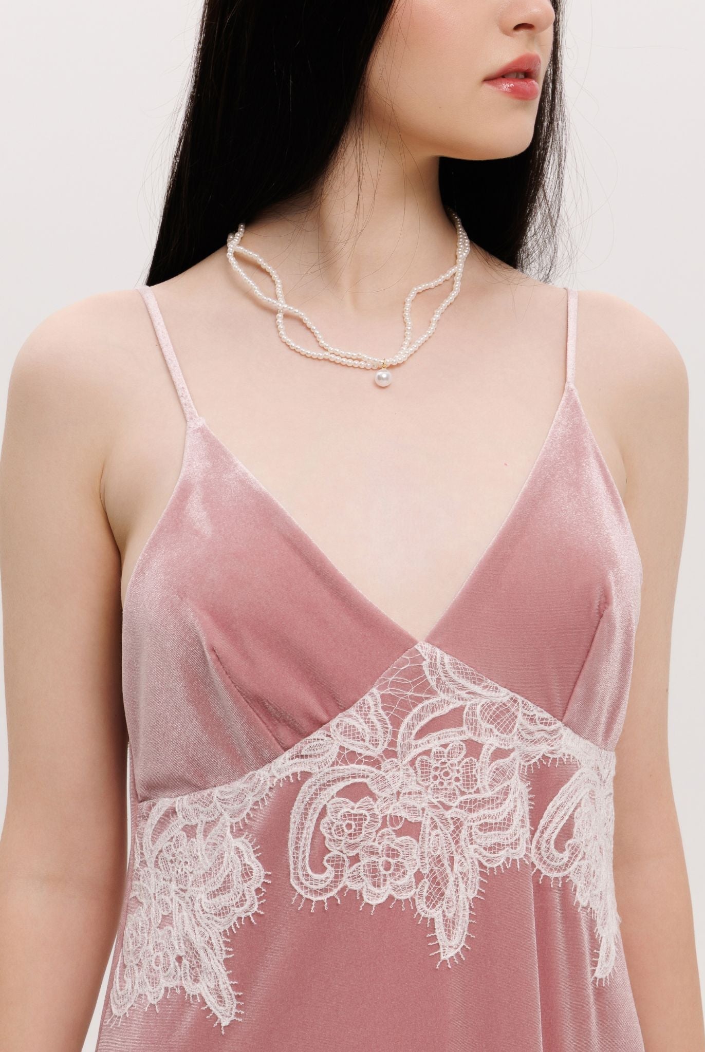 Close-up from neck to waist, highlighting the flattering V-neck and the soft, plush texture of the velvet.