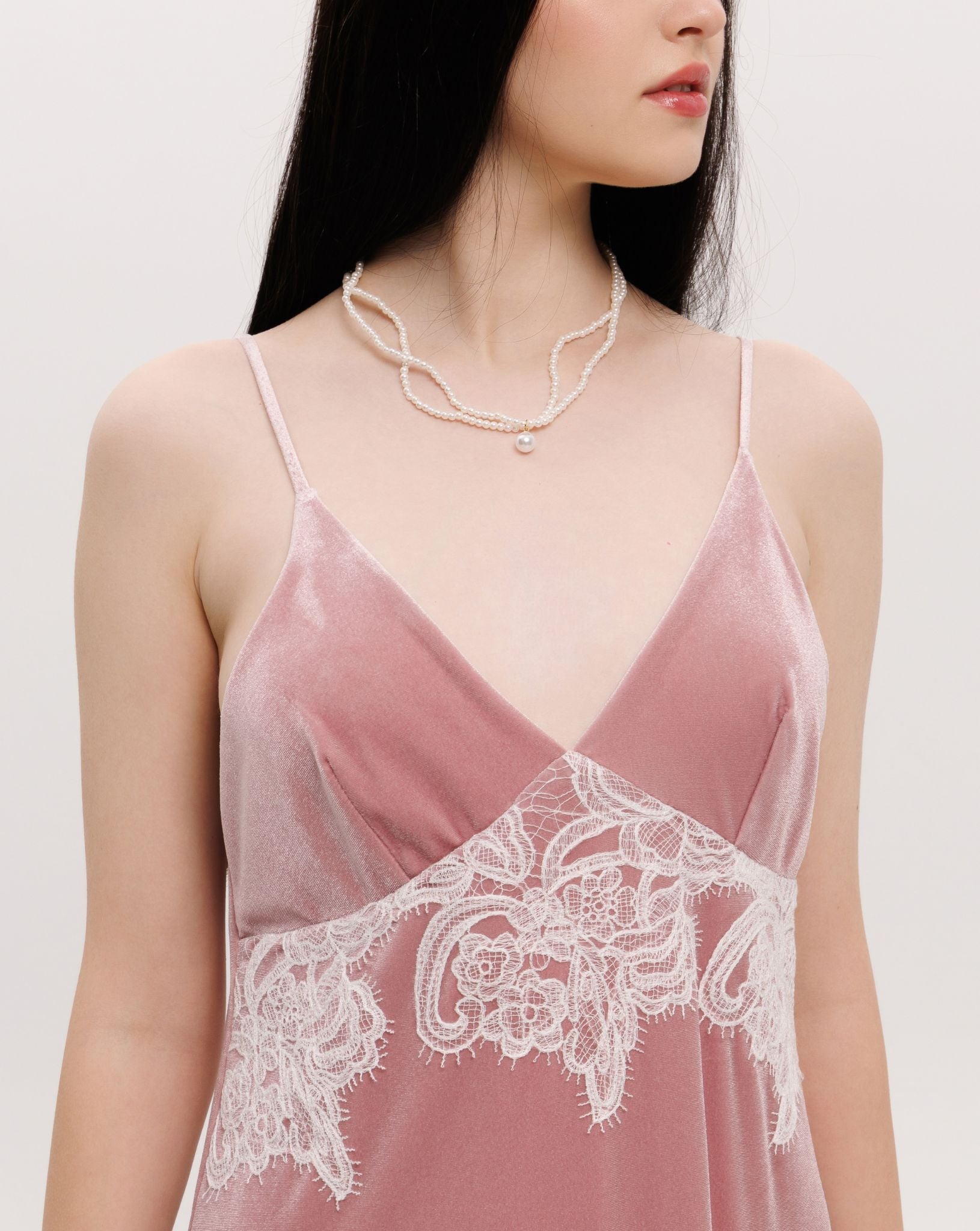 Close-up from neck to waist, highlighting the flattering V-neck and the soft, plush texture of the velvet.