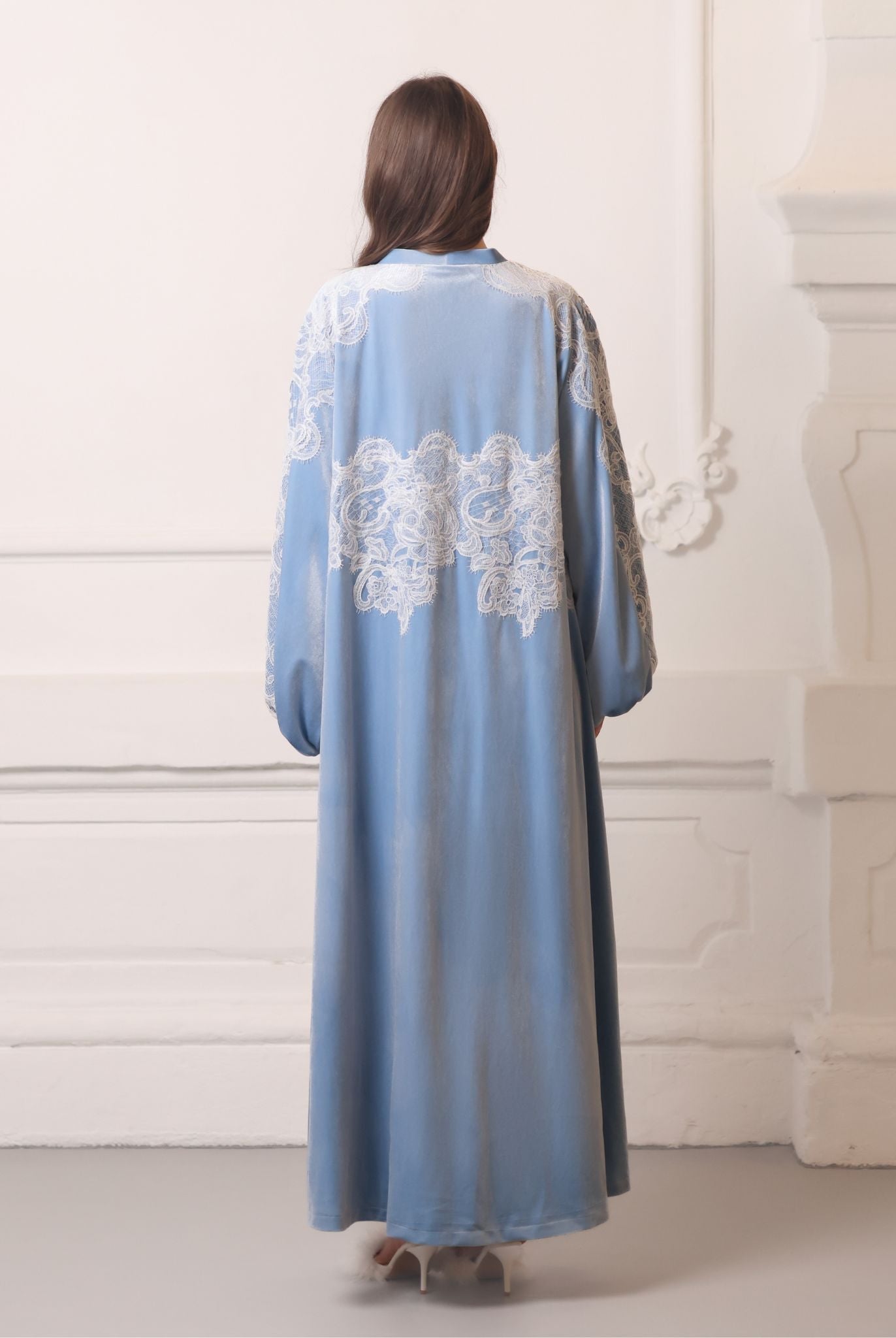 Back view of the floor-length ensemble, emphasizing the regal presence and effortless grandeur of the design.