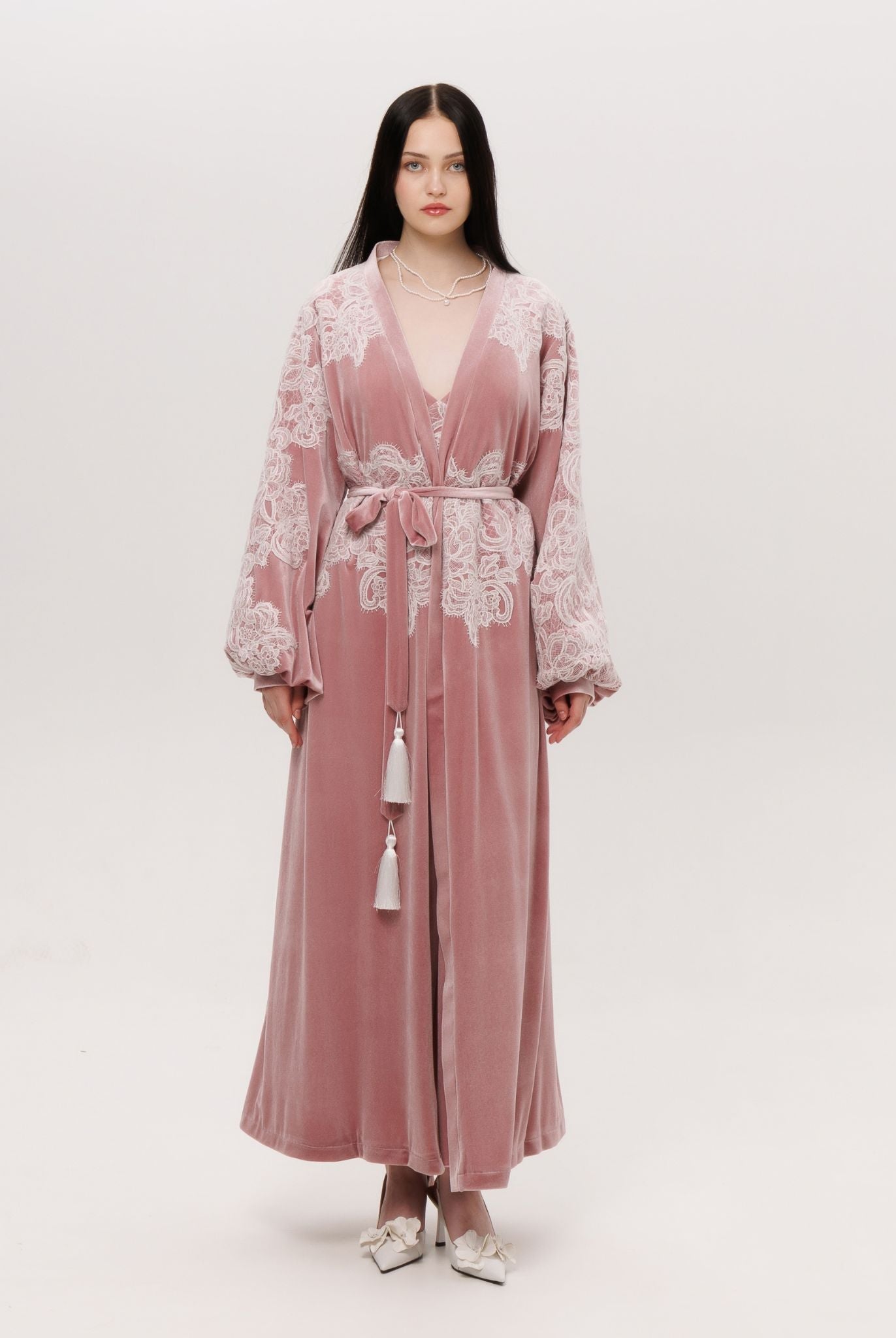 The velvet robe shown in a wrap-over style with a tie, creating a warm and regal presence for lounging.