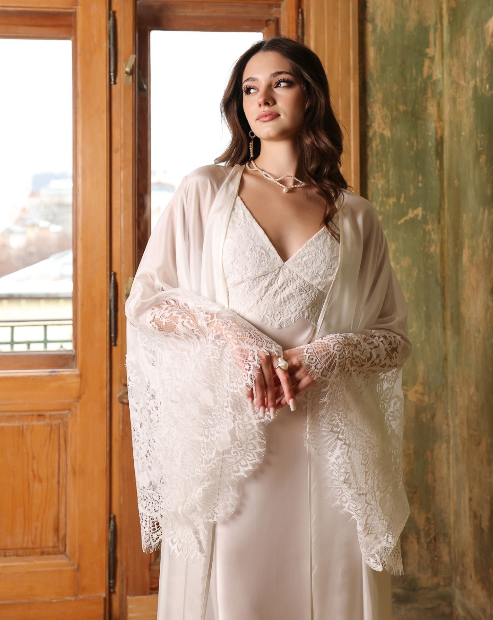 Half-body shot of the bridal silk wrap layered over a satin gown, highlighting the refined textures of the set.
