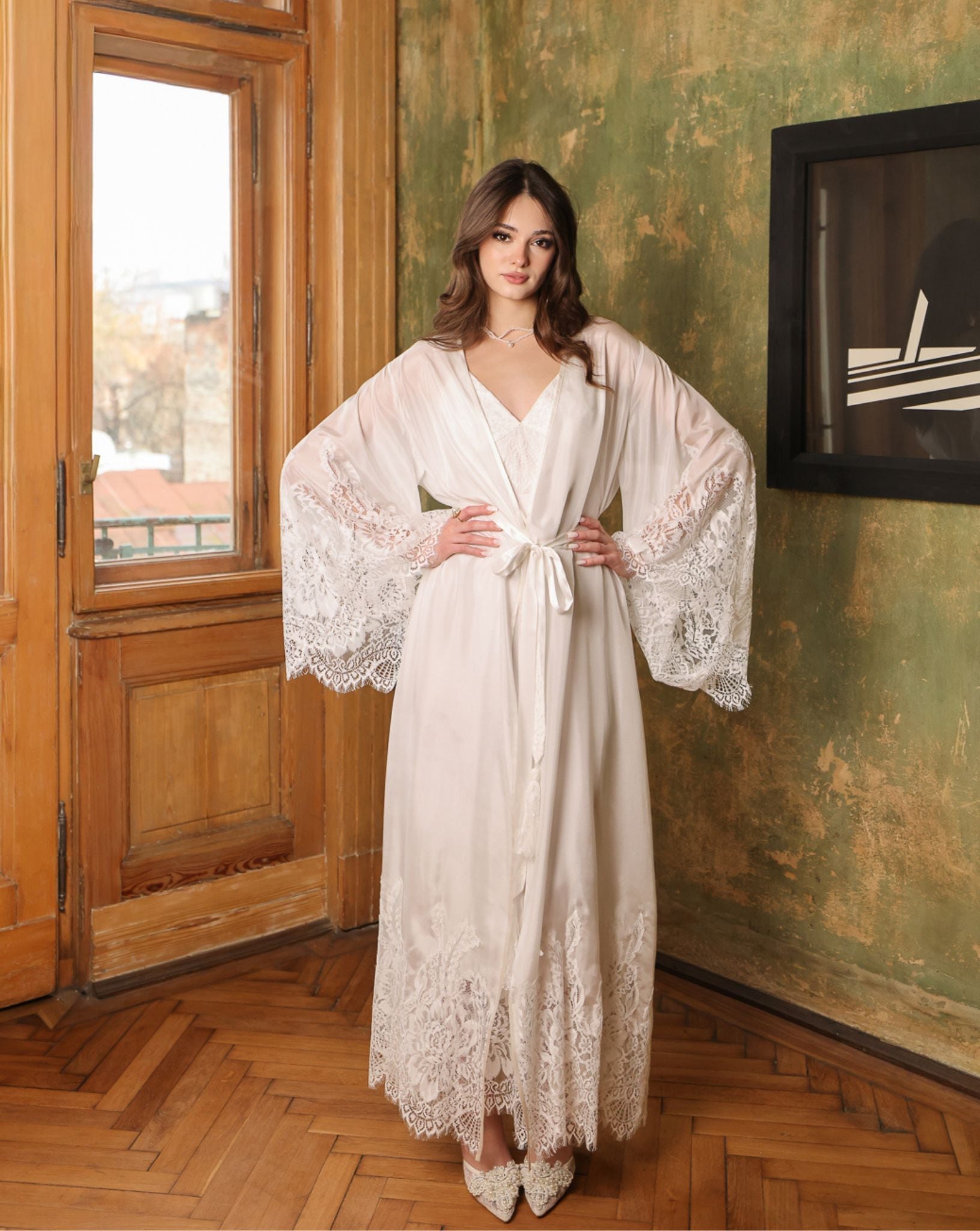 Frontal pose with hands on hips, displaying the voluminous lace-adorned sleeves and the feminine silhouette.