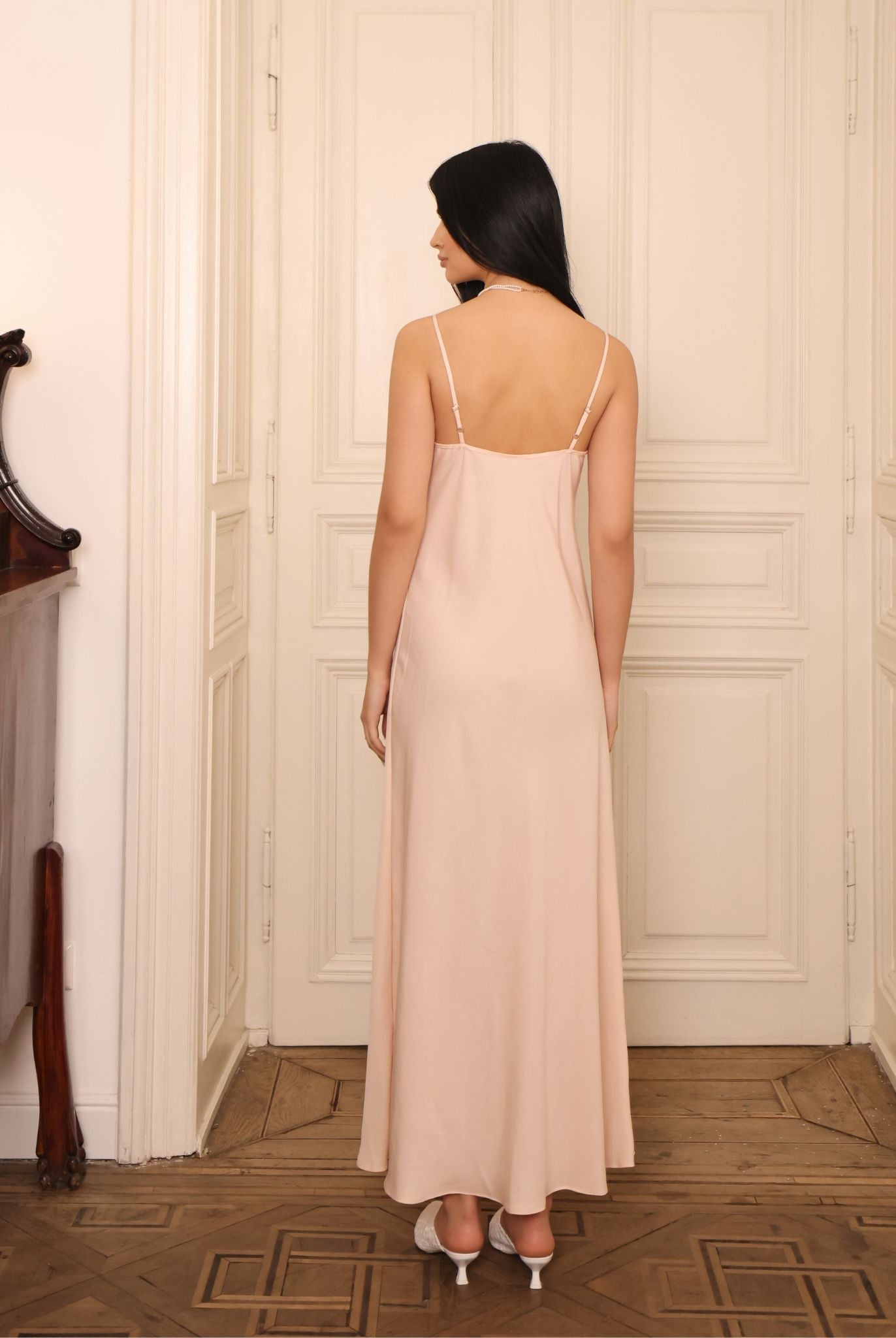 Rear view of the nightgown, showcasing the graceful drape of the breathable fabric and the elegant silhouette.