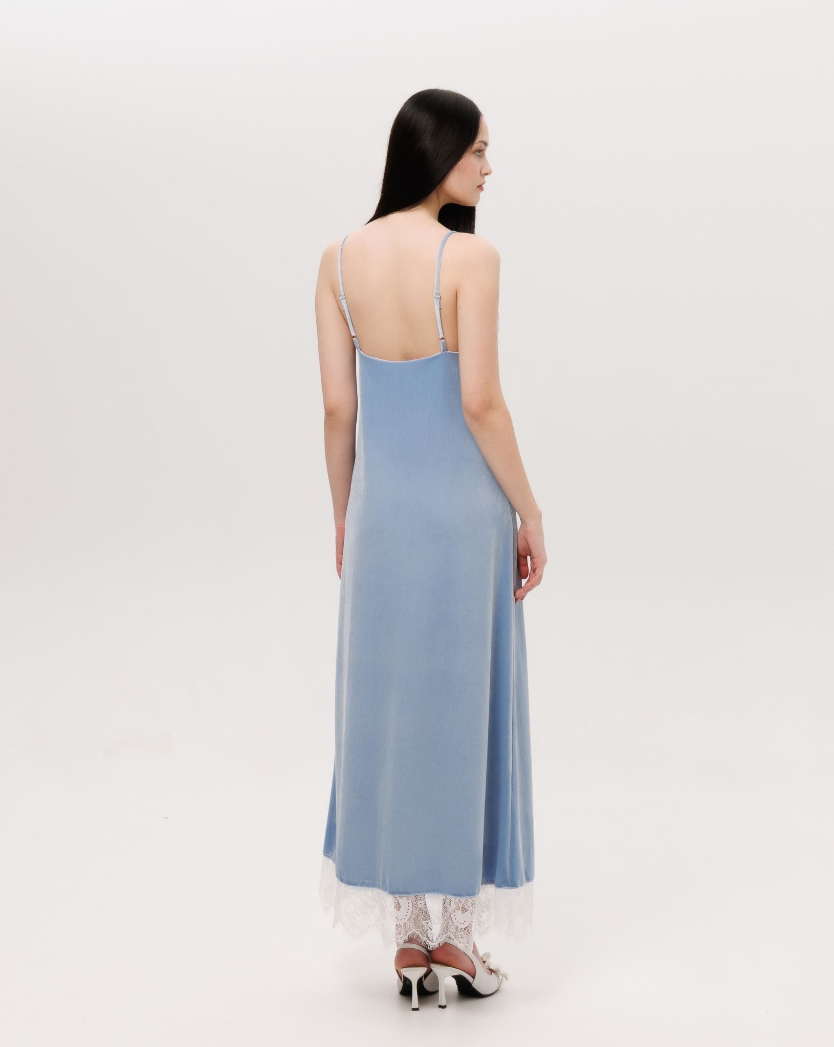 Rear view of the nightgown, highlighting the smooth drape of the velvet and the elegant length regulation.