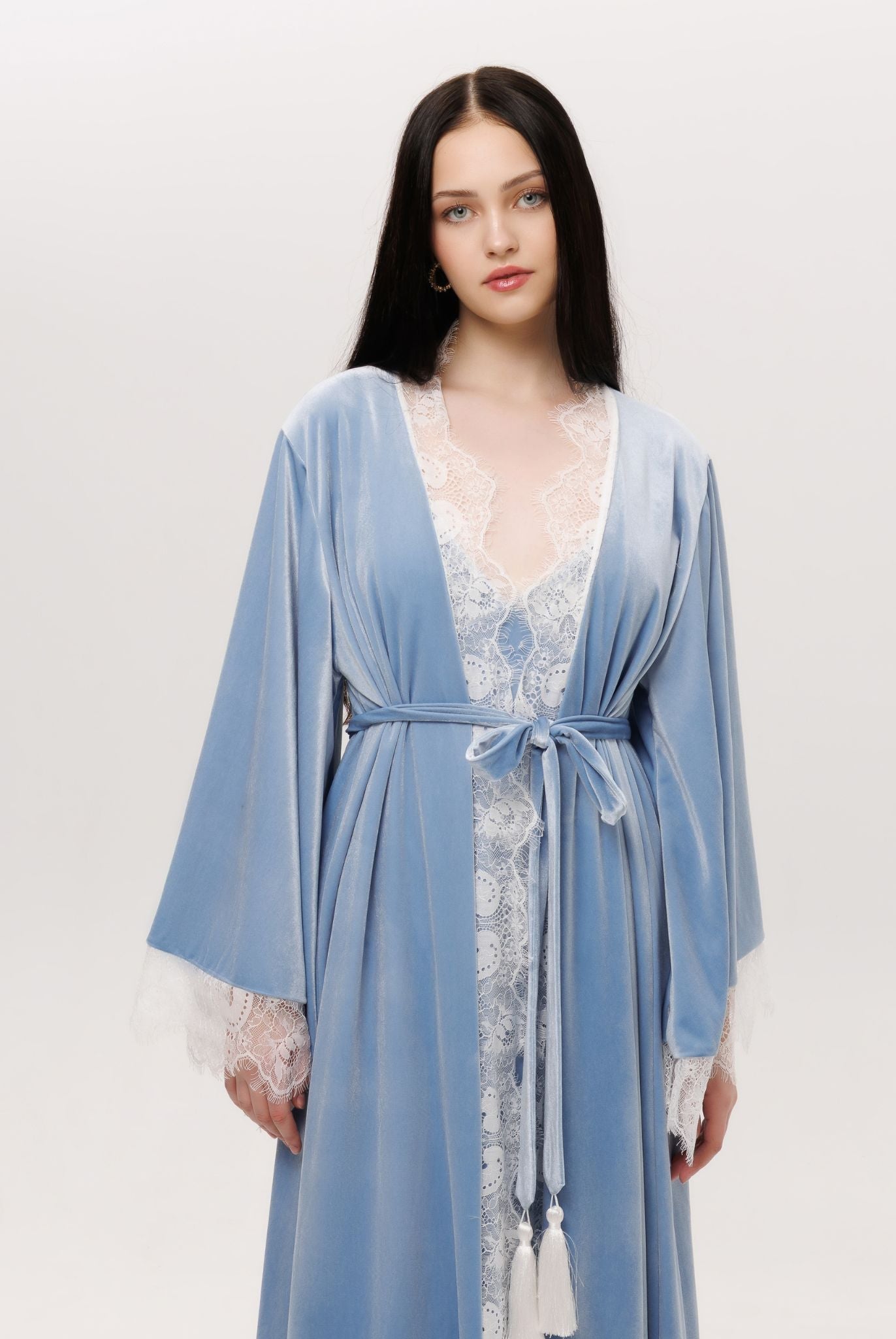 Mid-length shot of the tied robe, featuring delicate lace that traces the sleeves like delicate frost.