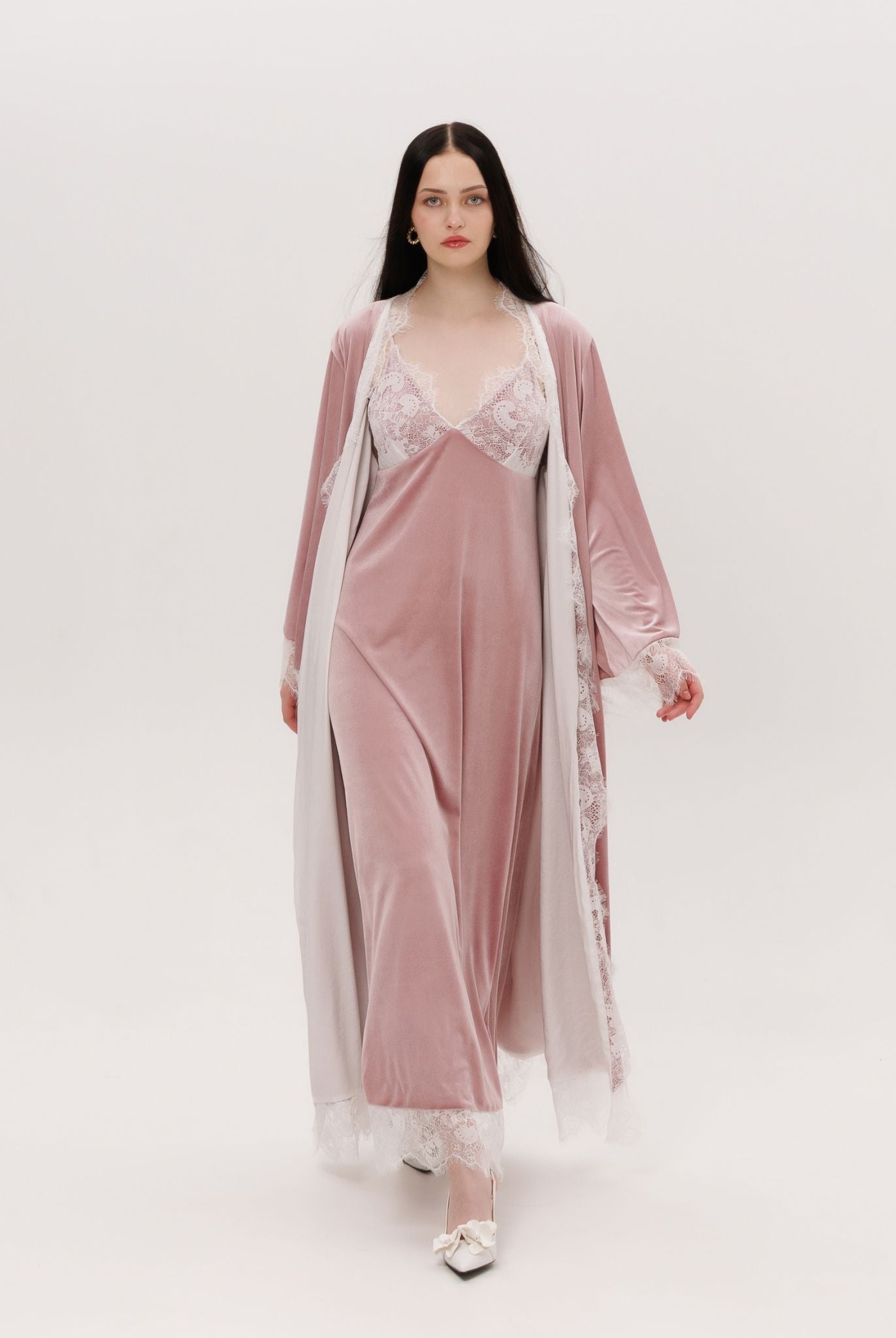 Capturing the graceful weight of the velvet ensemble as it moves, highlighting the effortless grandeur in every fold.