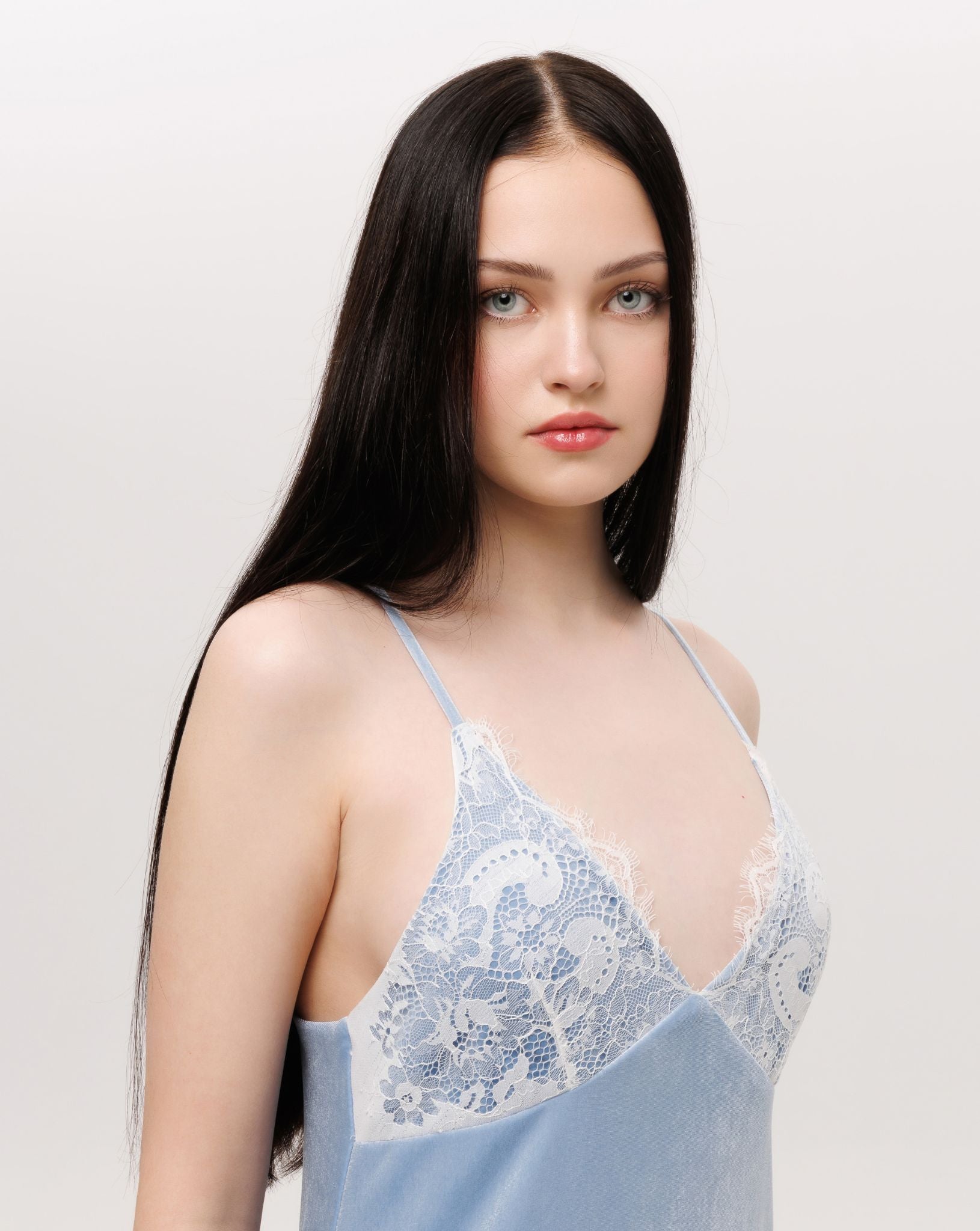 Detailed shot from head to waist, focusing on the soft texture of velvet and the exquisite lace patterns.