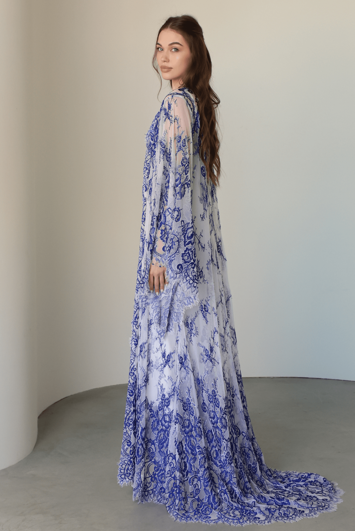 Back view of the complete ensemble, highlighting how the long lace train creates a dramatic, flowing look.