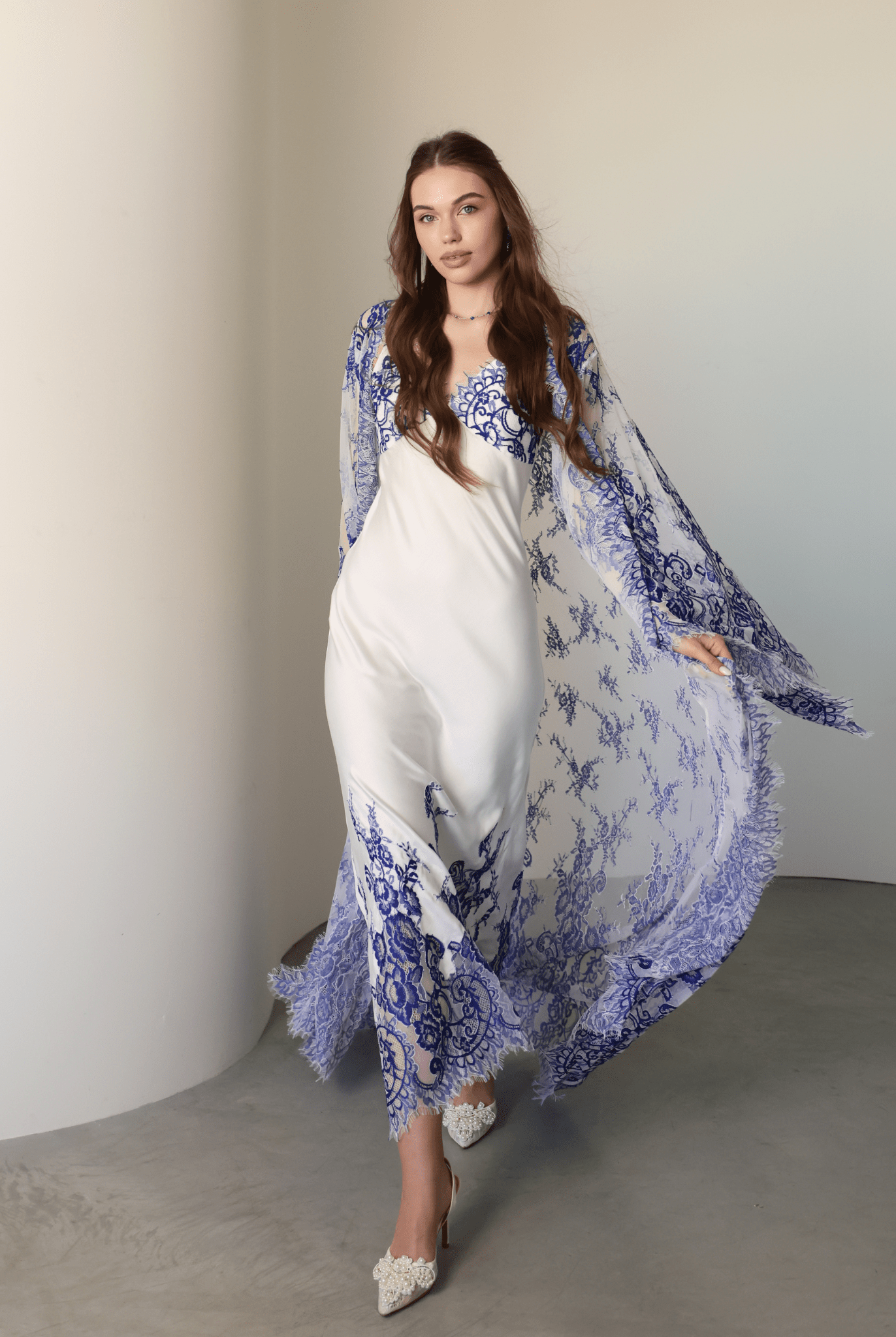 A dynamic view of the long lace train moving gracefully behind as the person walks through the room.