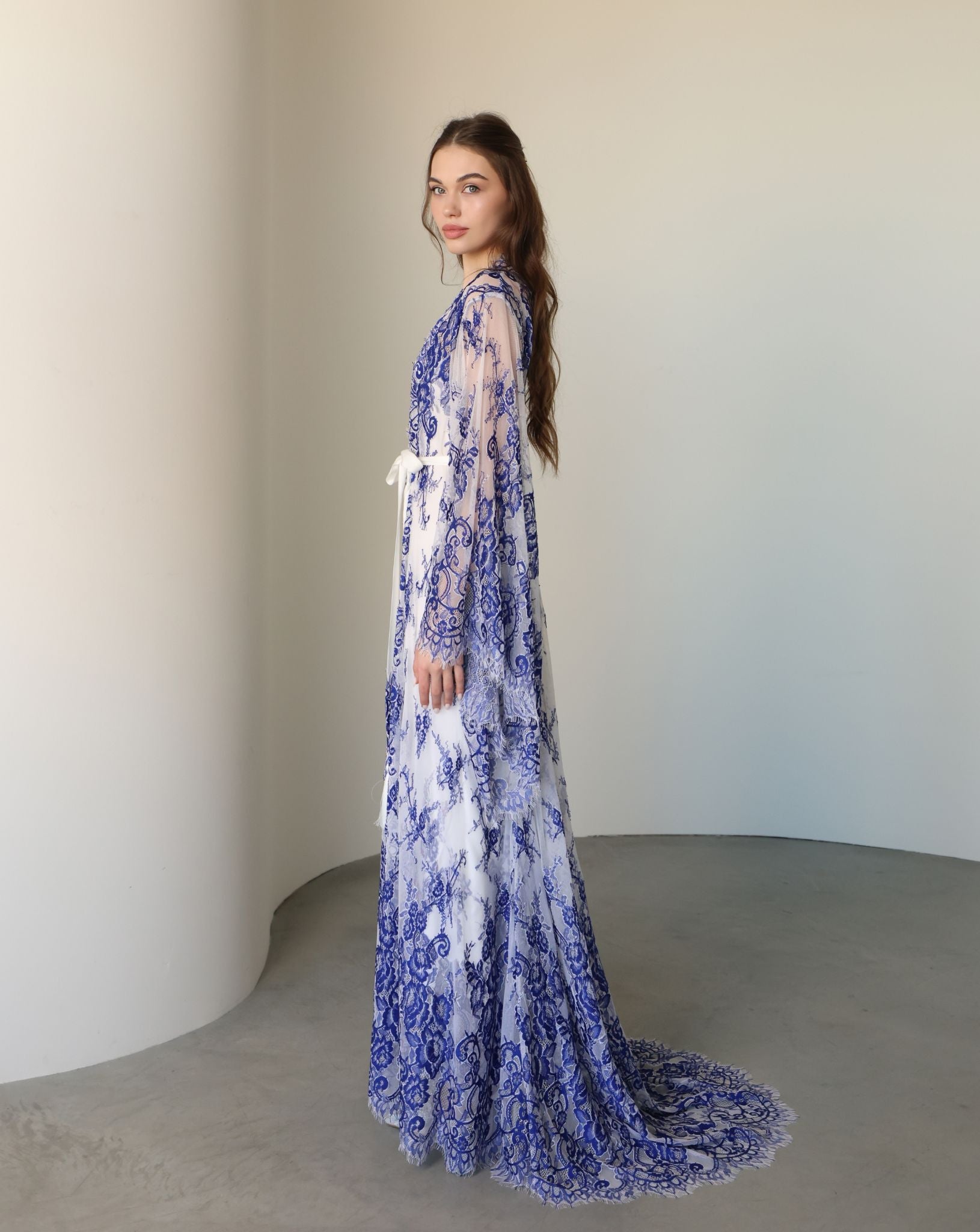 Side view focusing on the sweeping lace train and the delicate mix of materials designed for complete freedom.