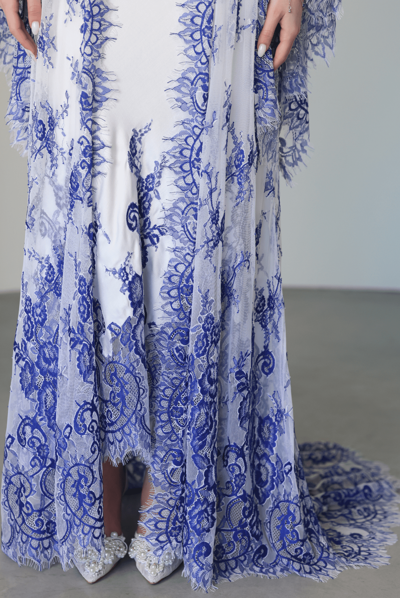Close-up of the nightgown's hem, focusing on the fine lace patterns and the smooth texture of the material.