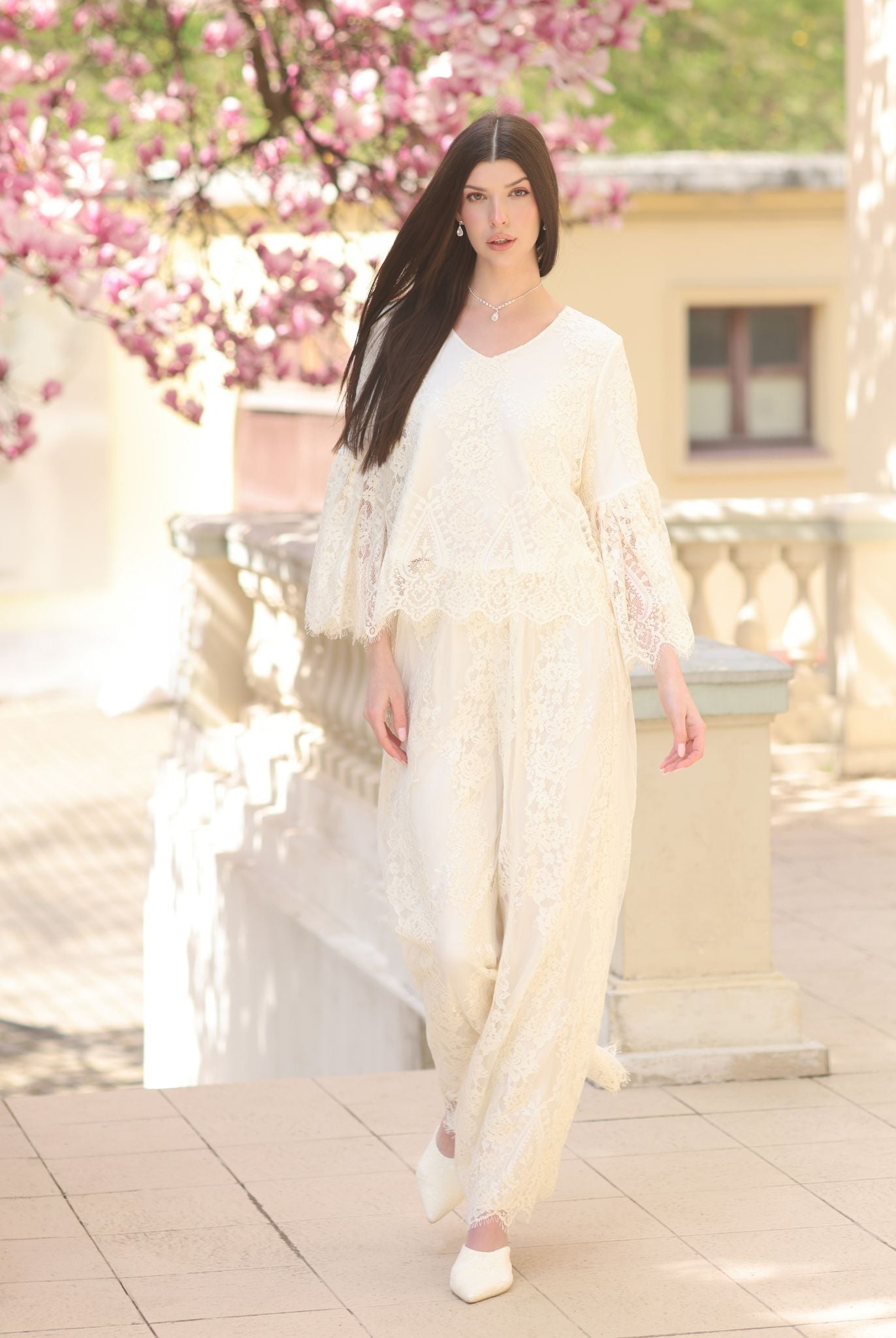 A dynamic motion shot of the Pajama Pants and Top, capturing the effortless silhouette and layered lace details.