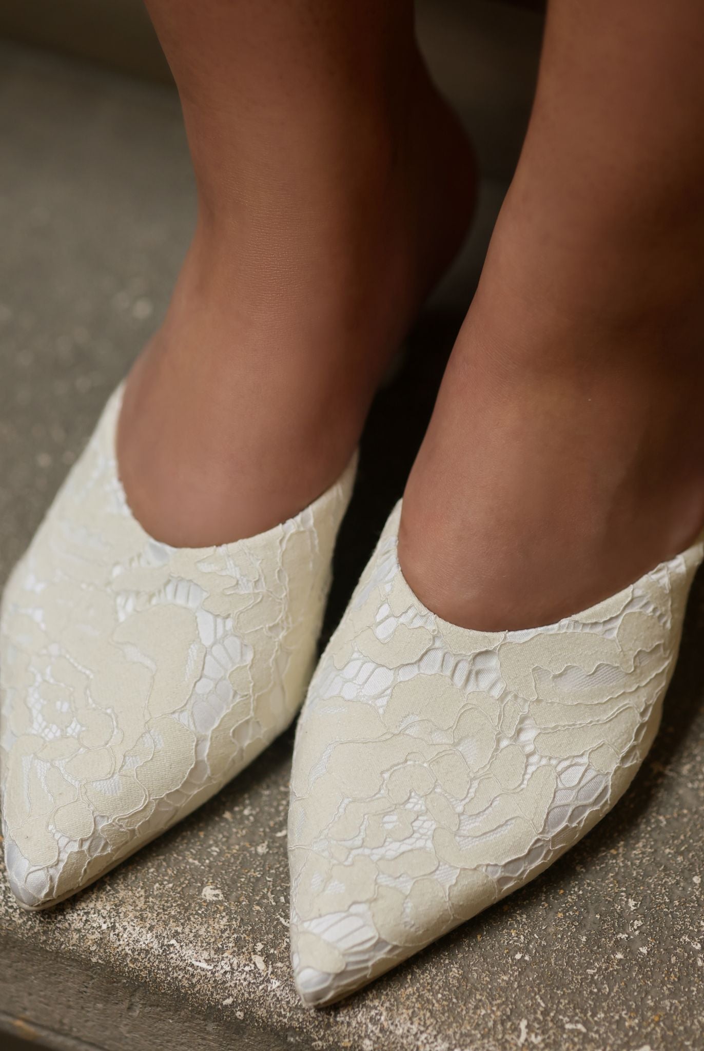 Top view of the Satin Slippers on feet, highlighting the delicate French lace and refined edge.