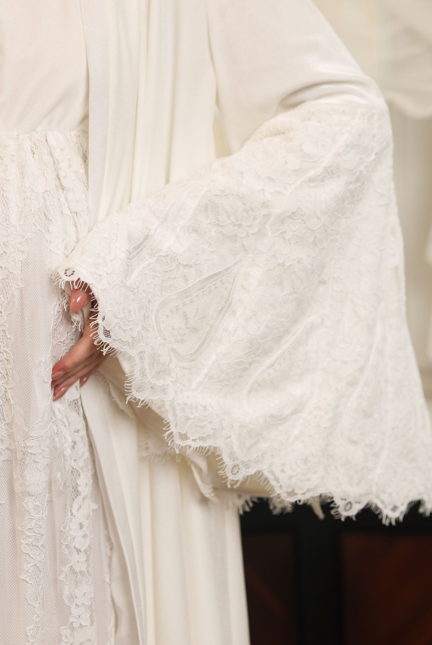 Detailed shot of the velvet sleeve, highlighting the exquisite lace work and the soft texture of the material.